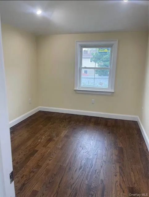 Empty room featuring dark wood-style flooring and recessed lighting Empty room featuring dark wood-style flooring and recessed lighting