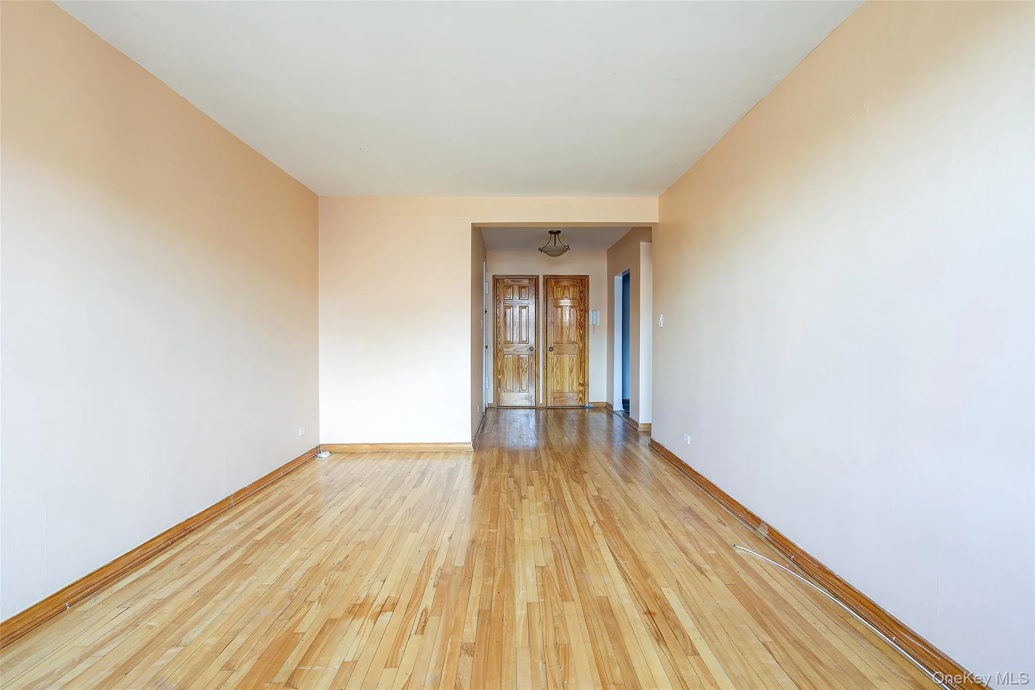 Spare room with light wood-style flooring and baseboards Spare room with light wood-style flooring and baseboards