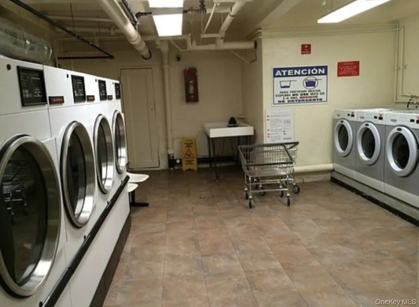 Shared laundry room with washing machine and dryer Shared laundry room with washing machine and dryer