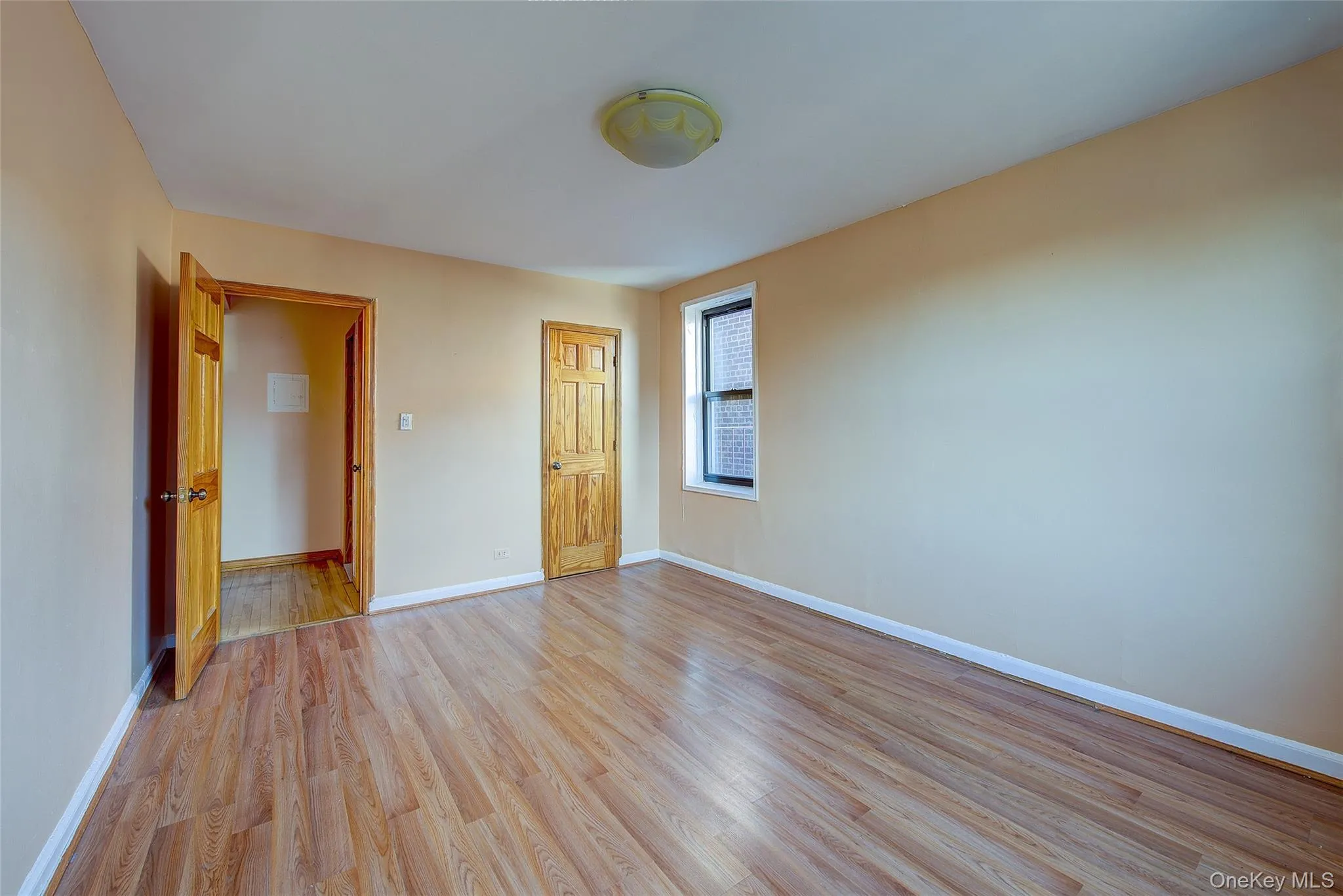 Unfurnished bedroom with light wood-type flooring and a closet Unfurnished bedroom with light wood-type flooring and a closet