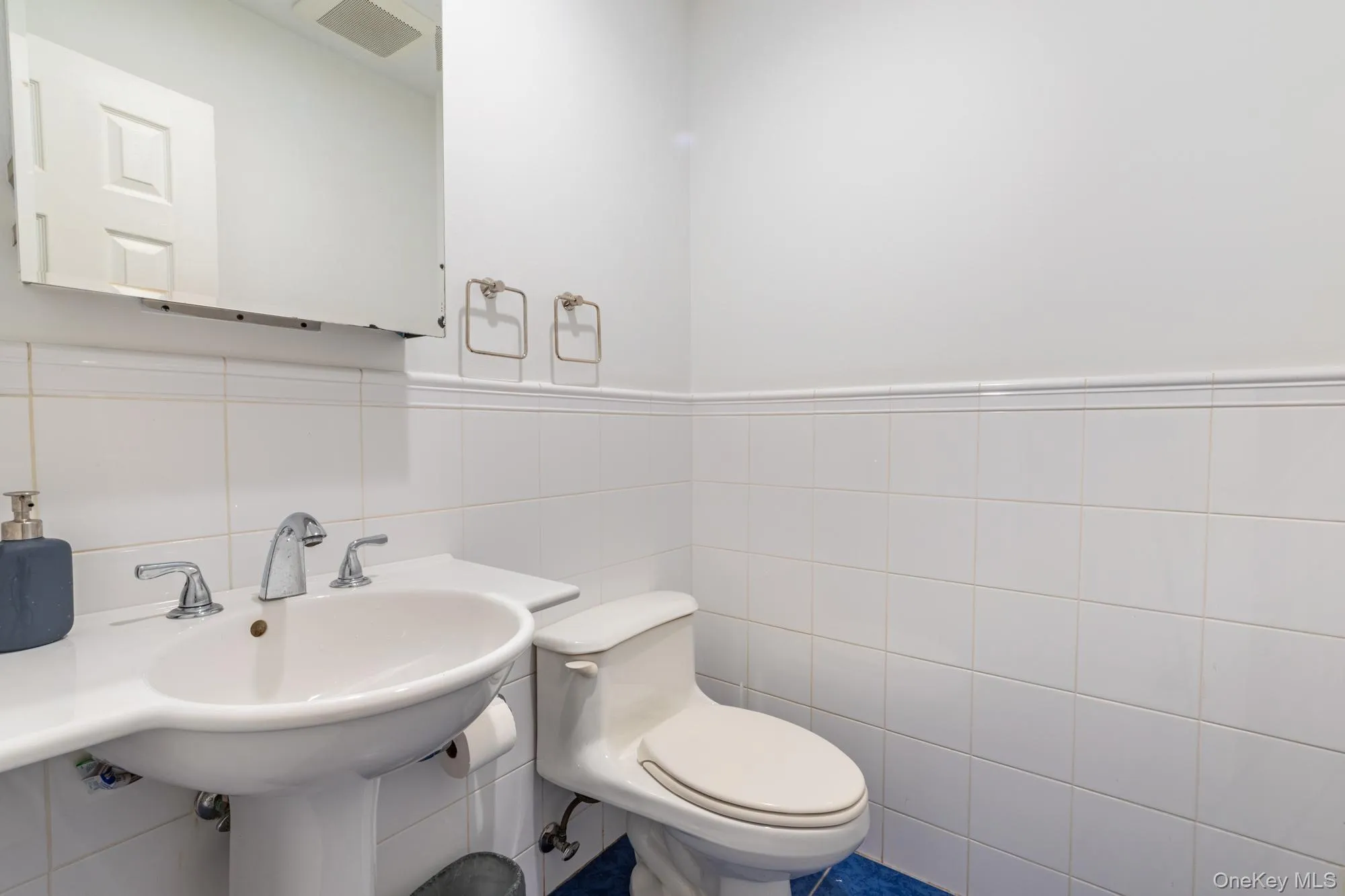 Half bath with tile walls and toilet Half bath with tile walls and toilet
