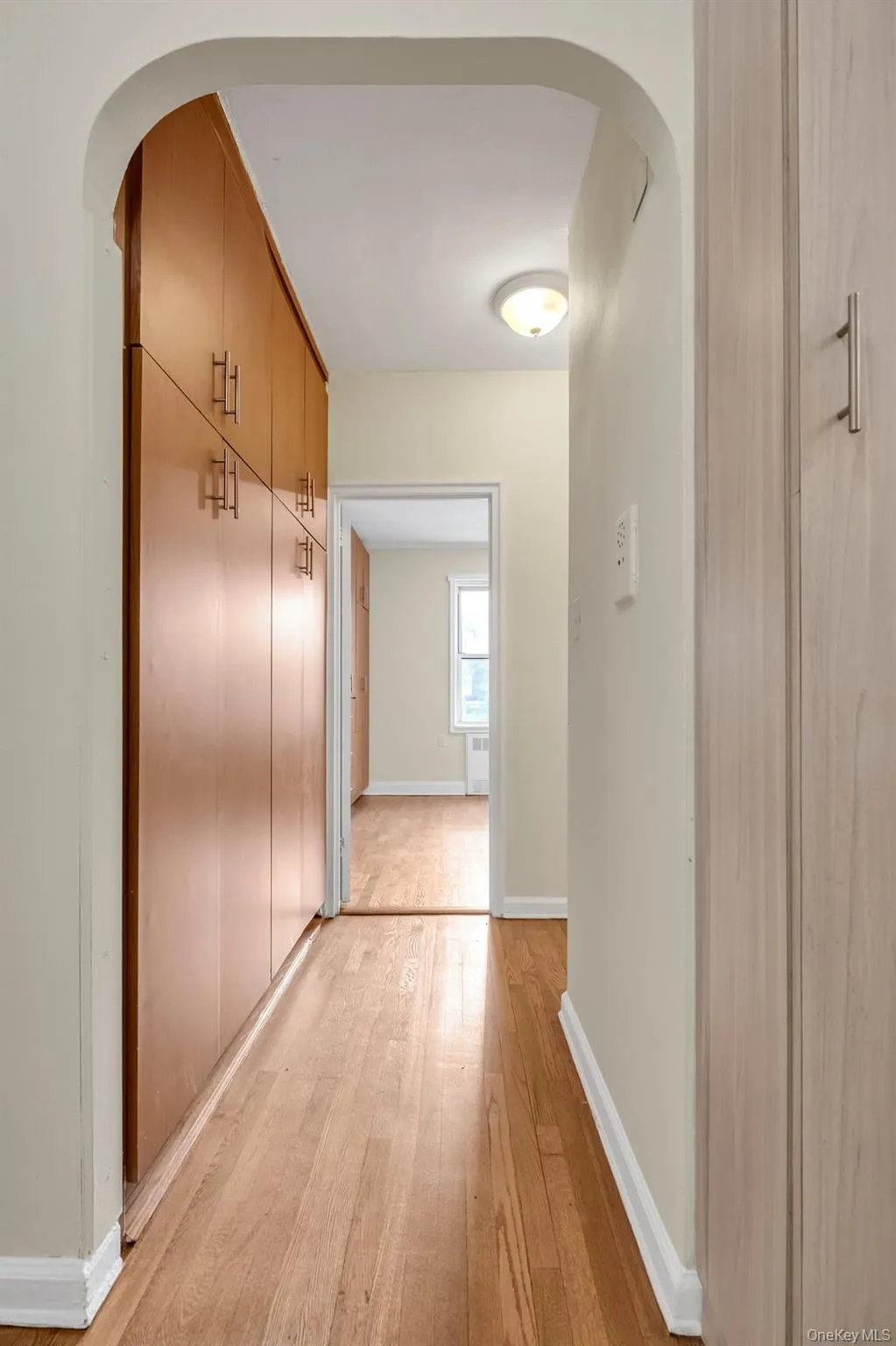 Corridor with arched walkways and light wood-type flooring Corridor with arched walkways and light wood-type flooring