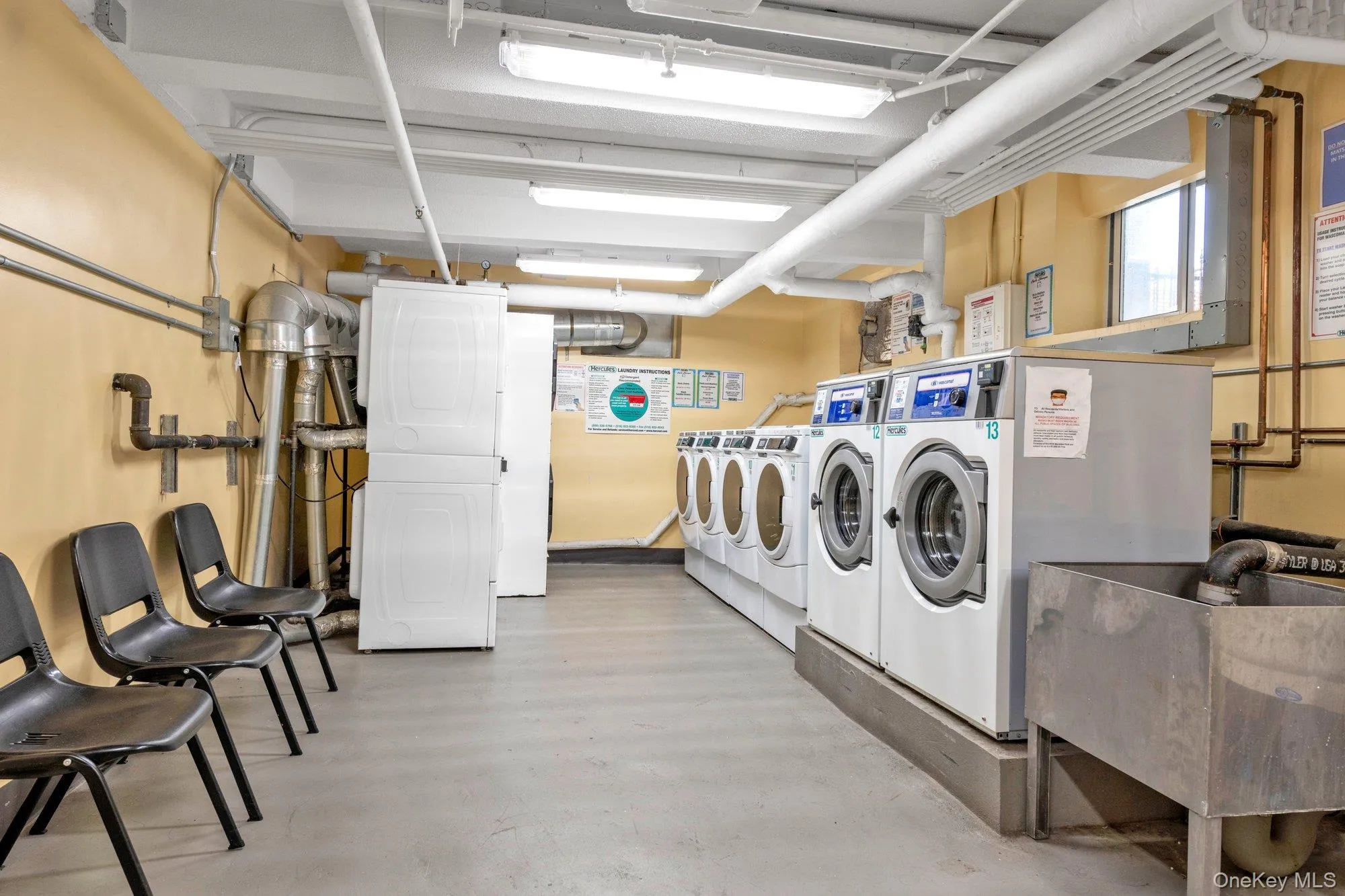 Communal laundry room featuring washing machine and dryer Communal laundry room featuring washing machine and dryer