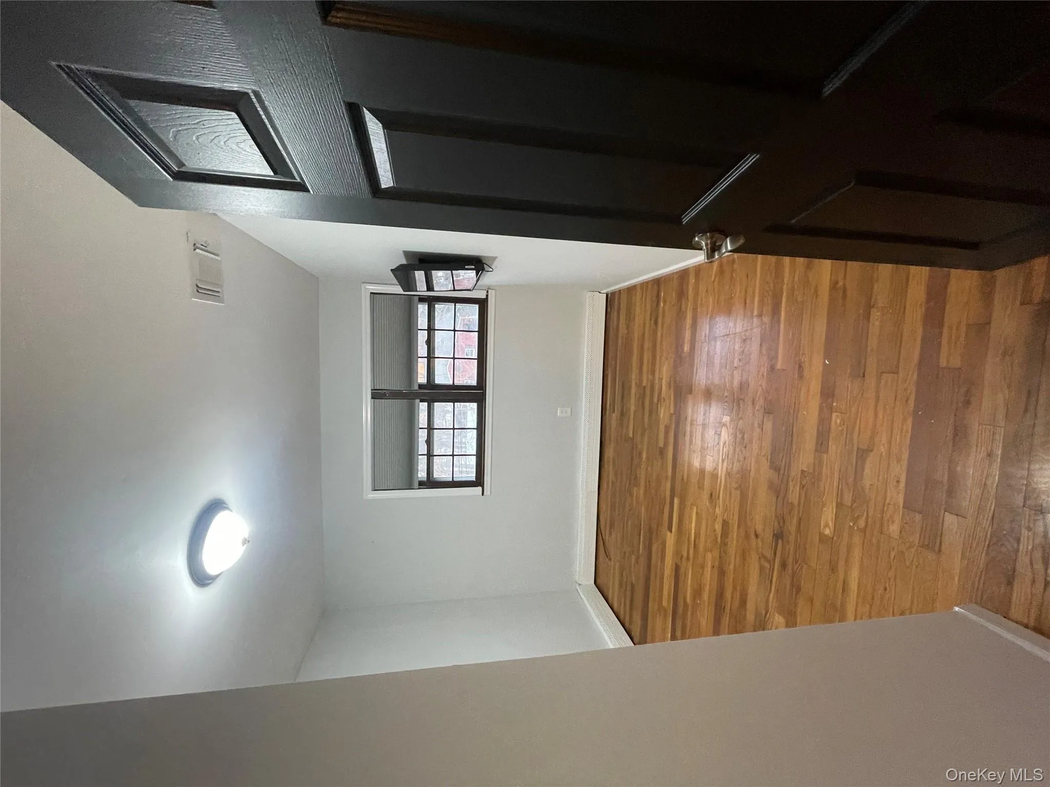 Spare room with baseboards and dark wood finished floors Spare room with baseboards and dark wood finished floors