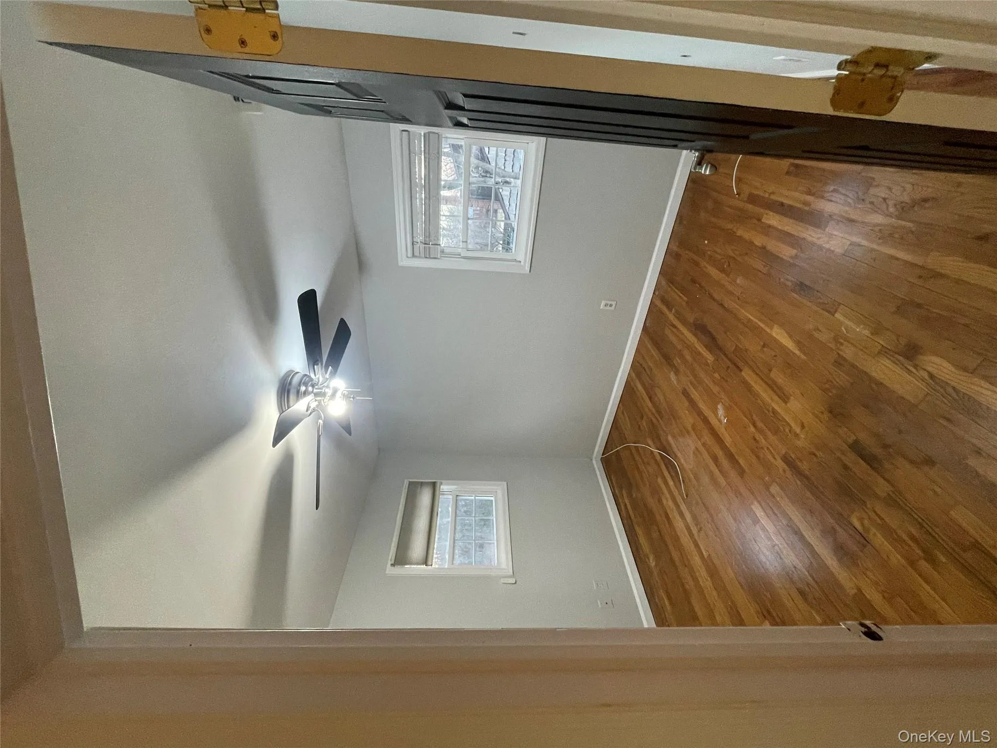 Spare room featuring dark wood-style flooring and ceiling fan Spare room featuring dark wood-style flooring and ceiling fan
