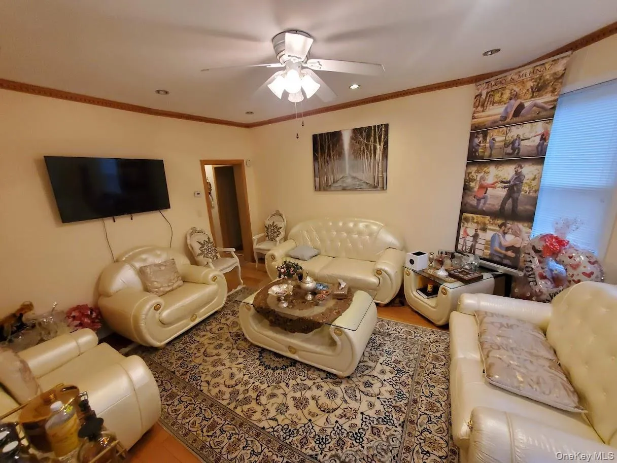 Living room featuring ornamental molding, a ceiling fan, and recessed lighting Living room featuring ornamental molding, a ceiling fan, and recessed lighting