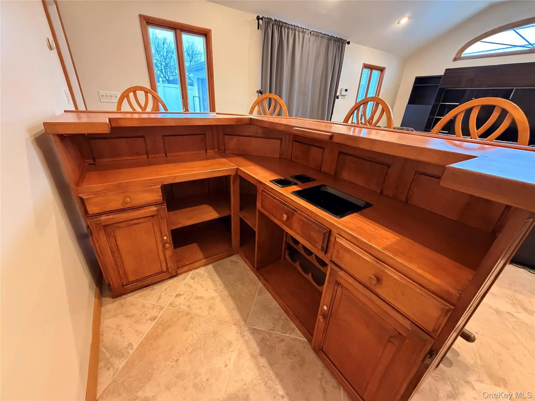 Kitchen with lofted ceiling, wooden counters, and brown cabinets Kitchen with lofted ceiling, wooden counters, and brown cabinets