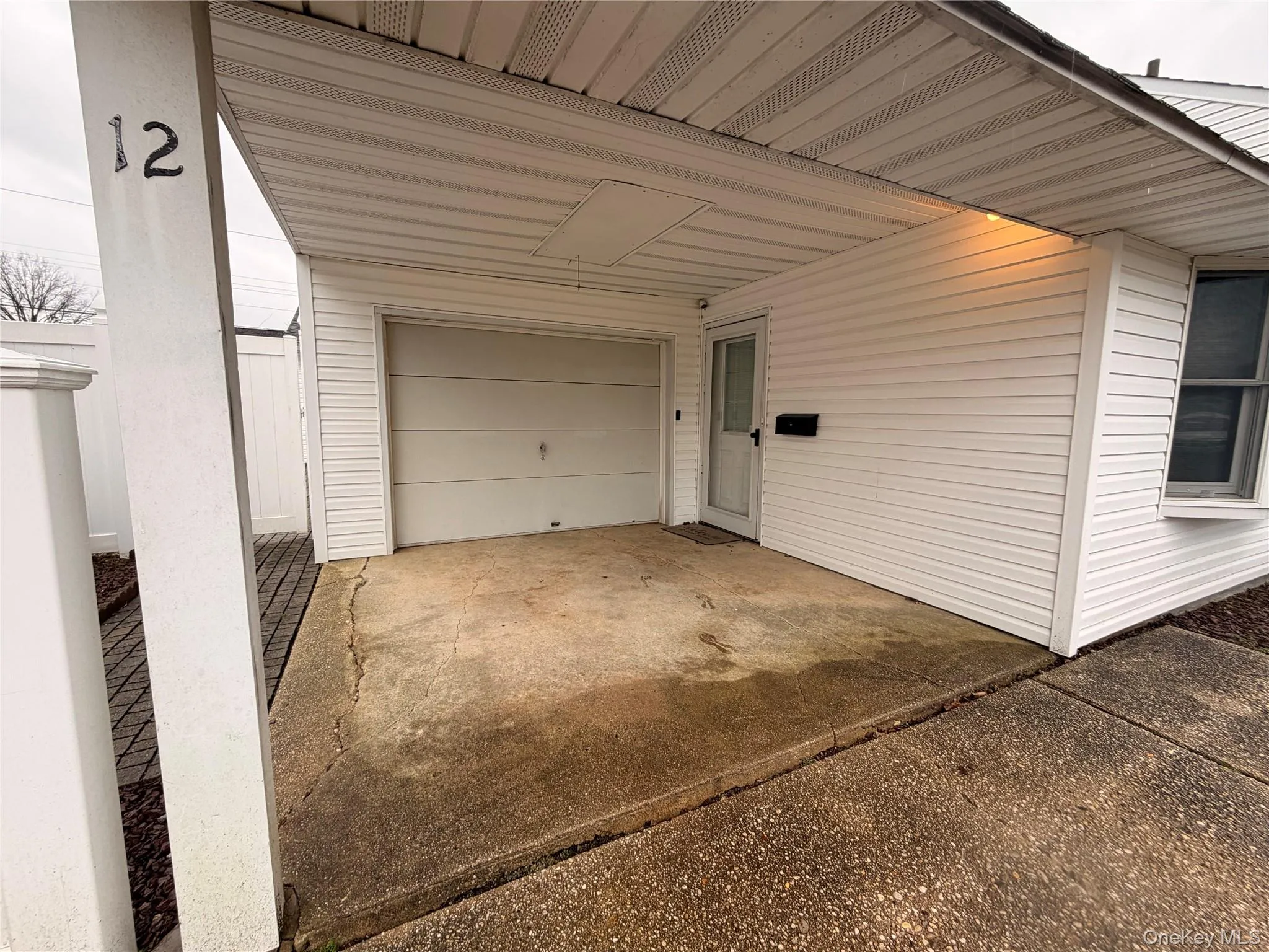Garage featuring concrete driveway Garage featuring concrete driveway