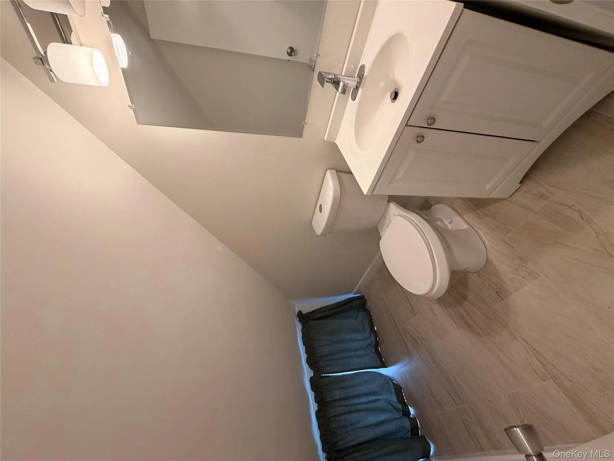 Half bath with vanity and vaulted ceiling Half bath with vanity and vaulted ceiling