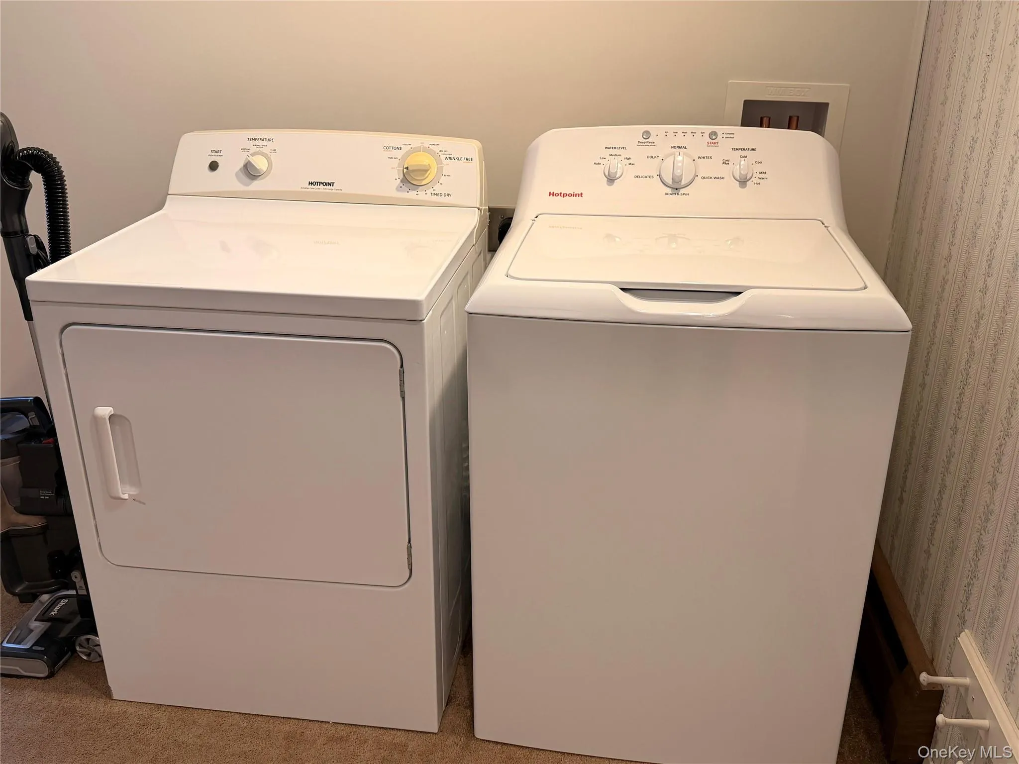 Laundry area featuring independent washer and dryer and light colored carpet Laundry area featuring independent washer and dryer and light colored carpet