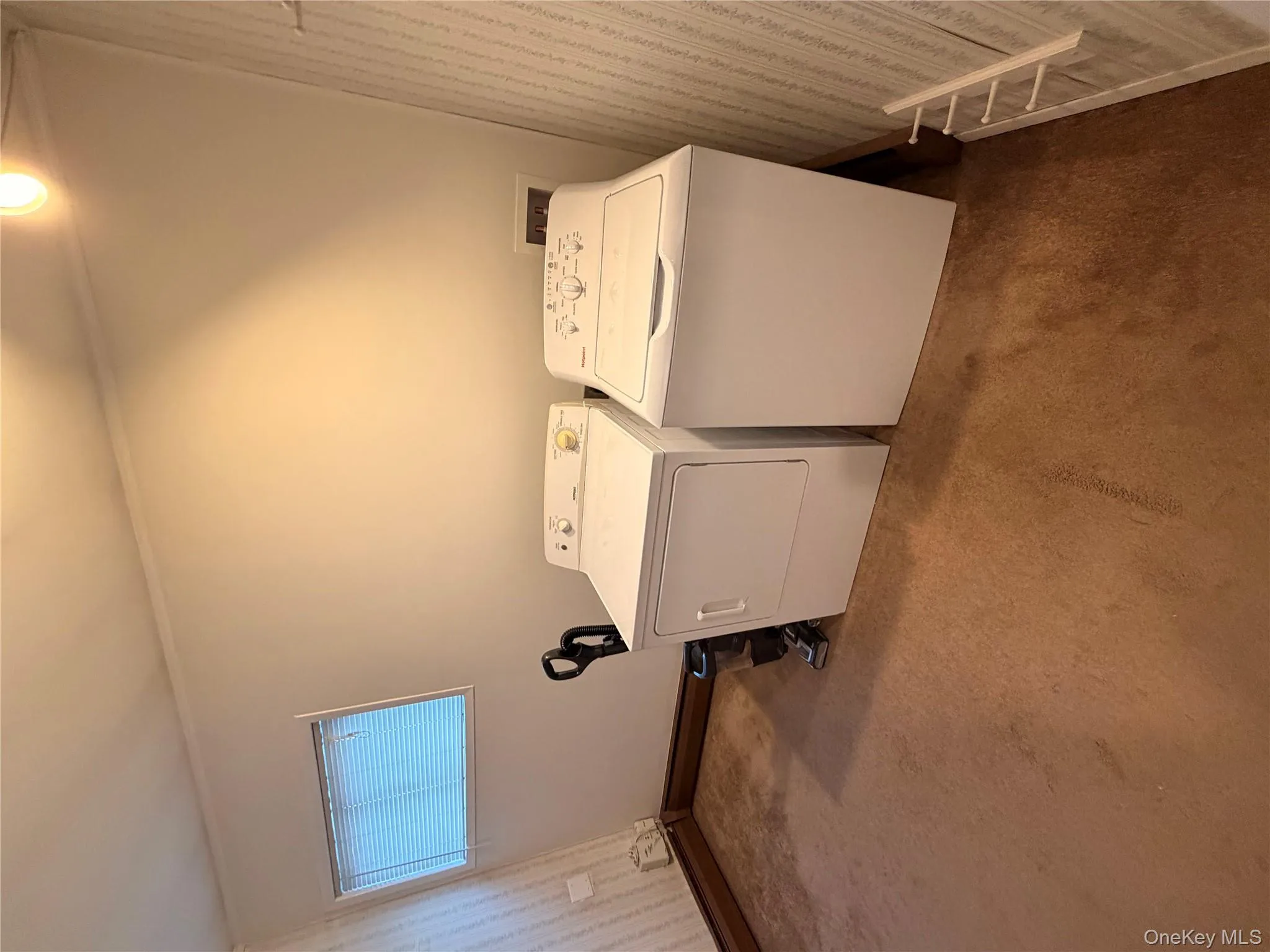 Laundry area with washer and dryer, carpet floors, and crown molding Laundry area with washer and dryer, carpet floors, and crown molding