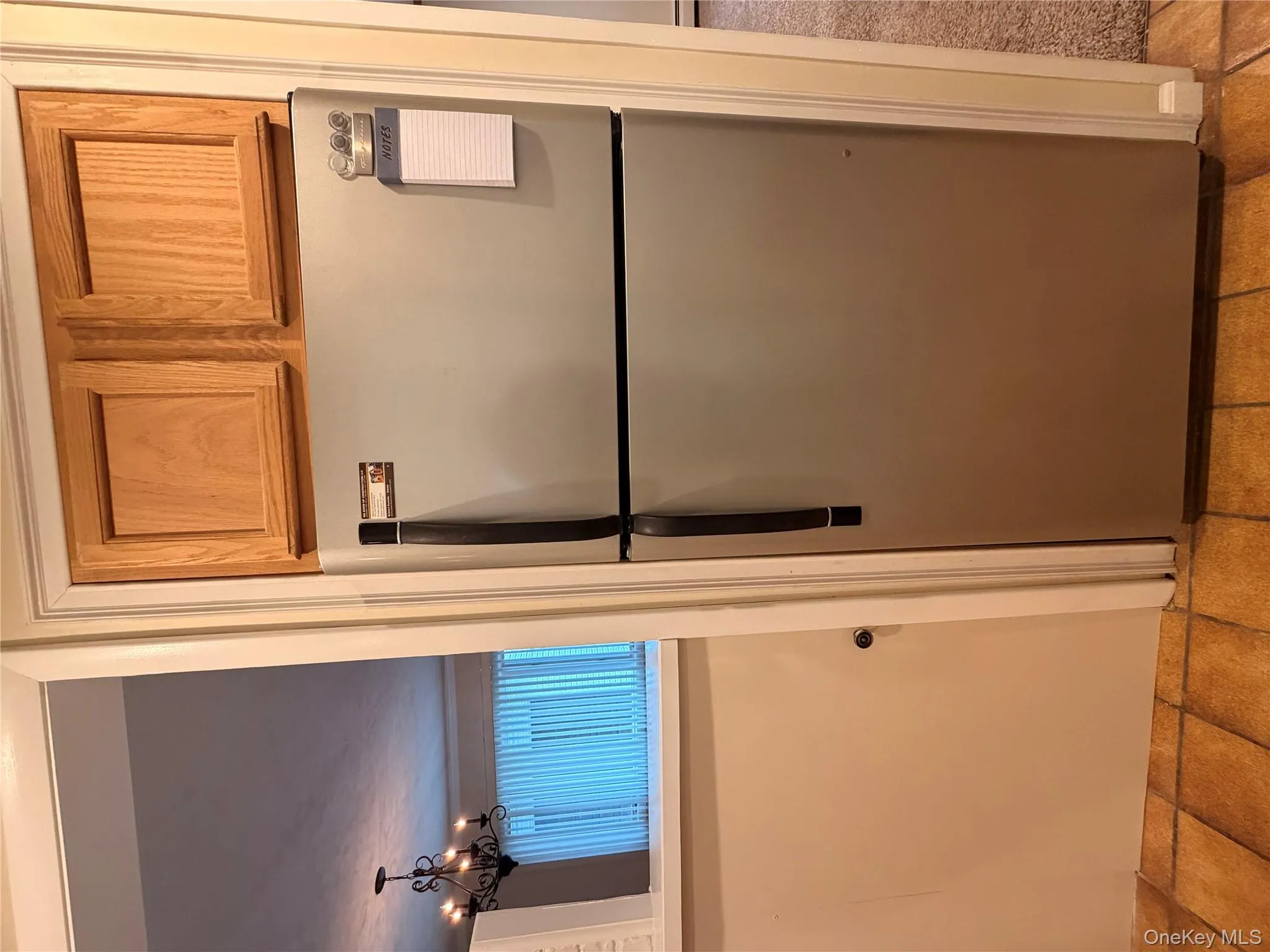 Kitchen with freestanding refrigerator and a chandelier Kitchen with freestanding refrigerator and a chandelier