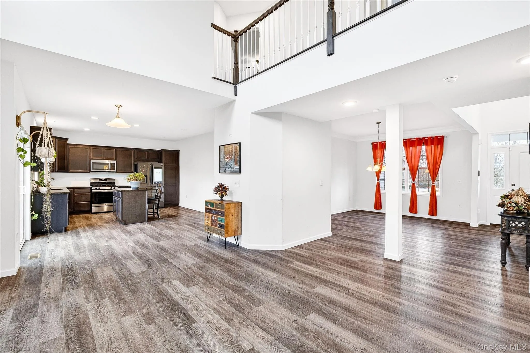 Living area with recessed lighting, light wood finished floors, plenty of natural light, and a chandelier Living area with recessed lighting, light wood finished floors, plenty of natural light, and a chandelier