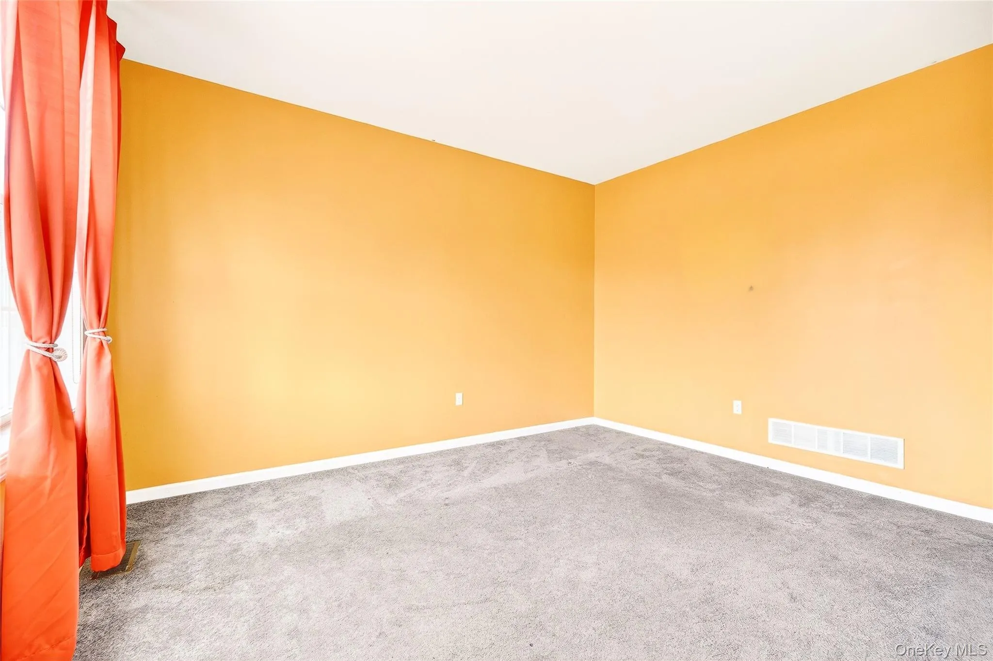 Empty room featuring carpet and baseboards Empty room featuring carpet and baseboards