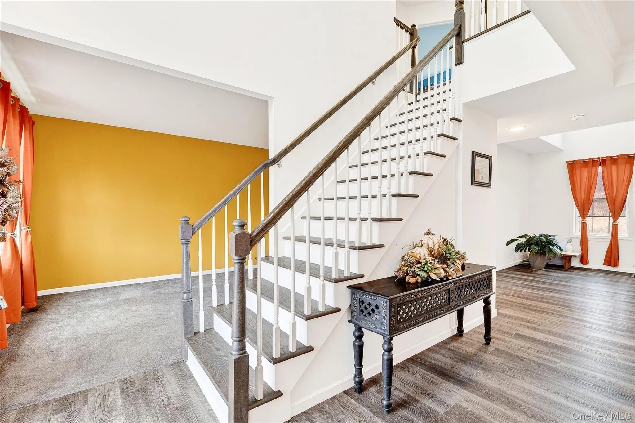 Staircase with wood finished floors and a towering ceiling Staircase with wood finished floors and a towering ceiling