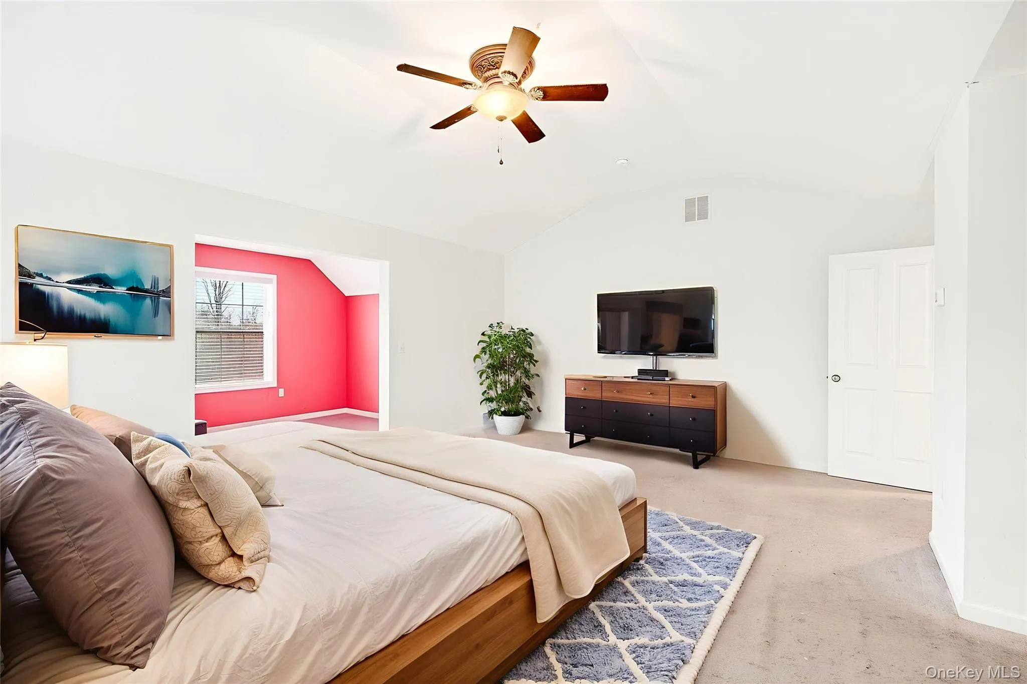 Bedroom with lofted ceiling, carpet flooring, and ceiling fan Bedroom with lofted ceiling, carpet flooring, and ceiling fan