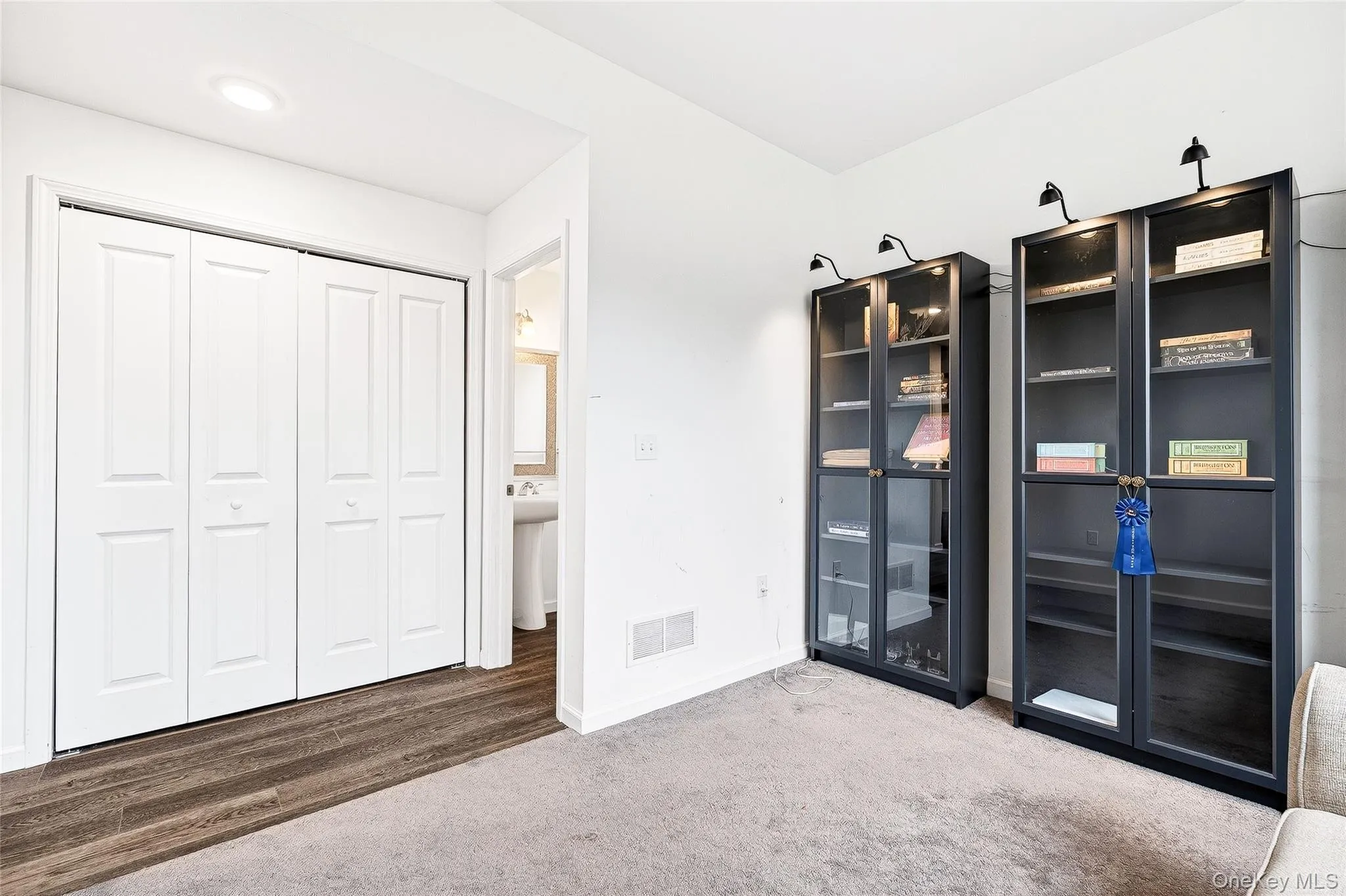 Unfurnished bedroom with a closet and carpet flooring Unfurnished bedroom with a closet and carpet flooring