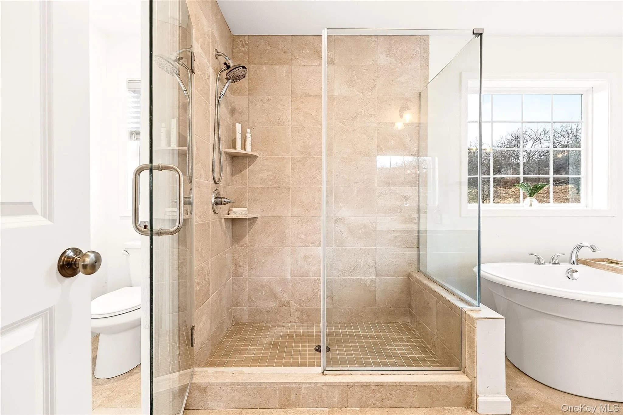 Full bathroom with a stall shower and a freestanding tub Full bathroom with a stall shower and a freestanding tub