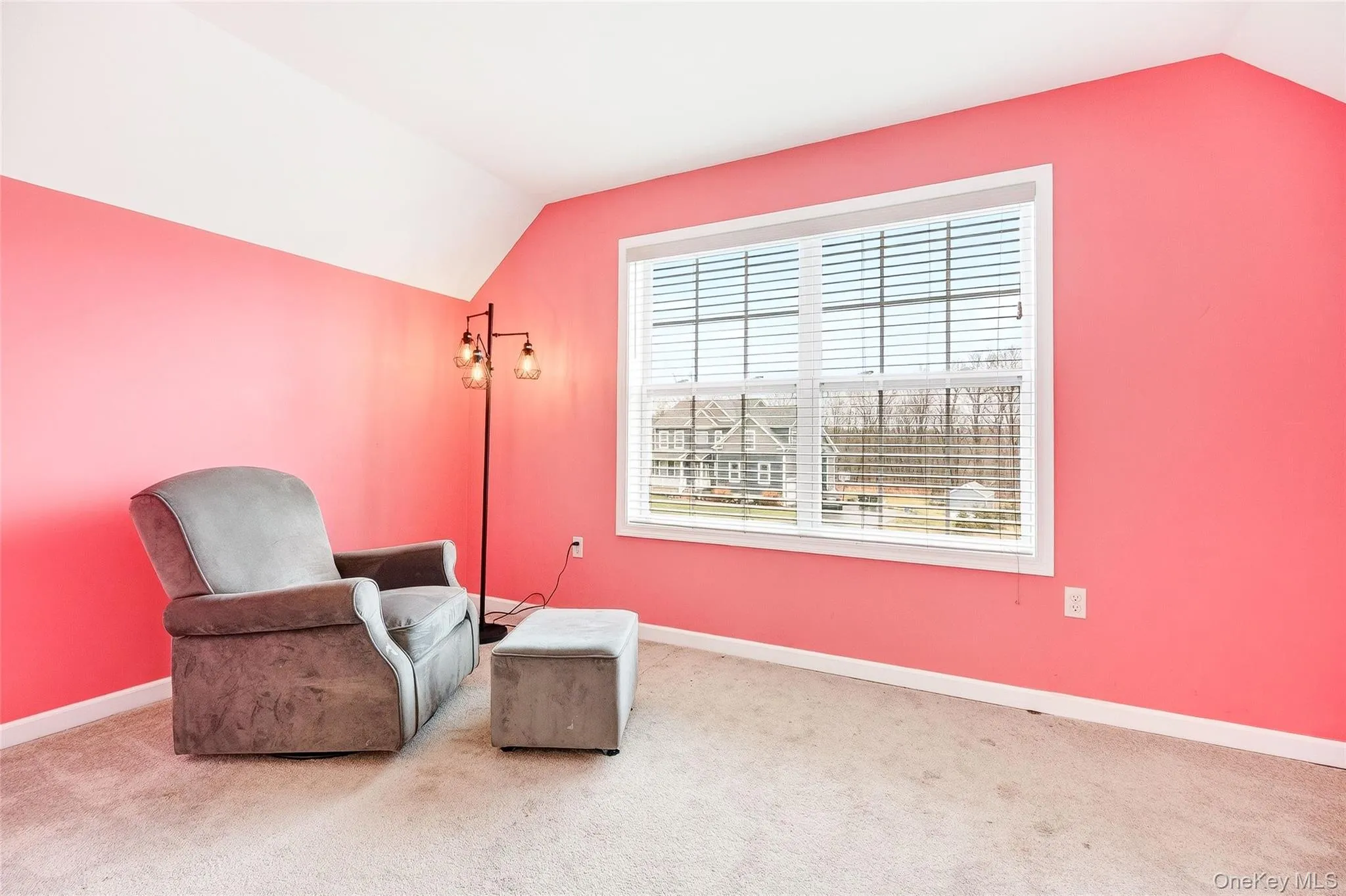 Sitting room with lofted ceiling and carpet flooring Sitting room with lofted ceiling and carpet flooring