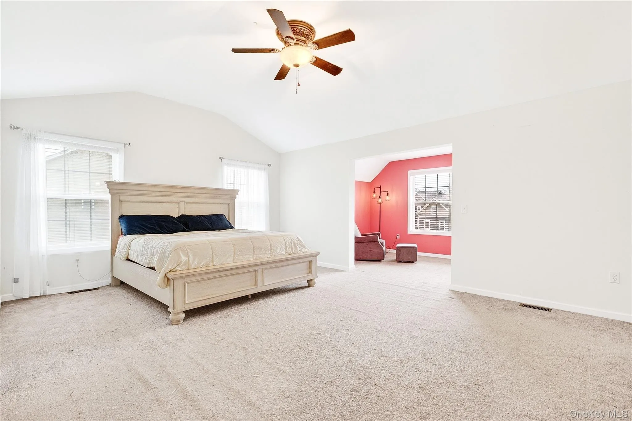 Bedroom with lofted ceiling, carpet flooring, and a ceiling fan Bedroom with lofted ceiling, carpet flooring, and a ceiling fan