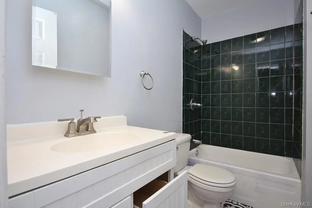 Bathroom featuring vanity and washtub / shower combination Bathroom featuring vanity and washtub / shower combination