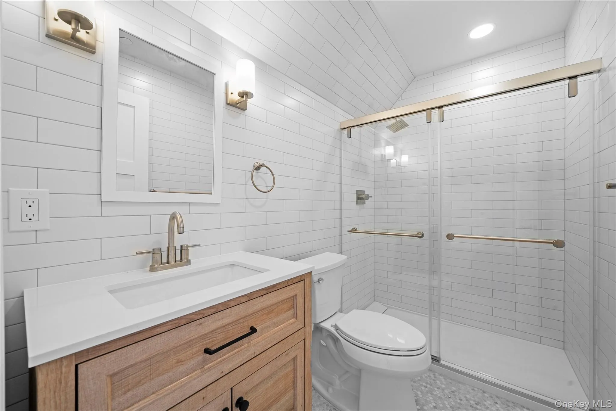 Bathroom with vanity, a shower stall, tile walls, tasteful backsplash, and recessed lighting Bathroom with vanity, a shower stall, tile walls, tasteful backsplash, and recessed lighting