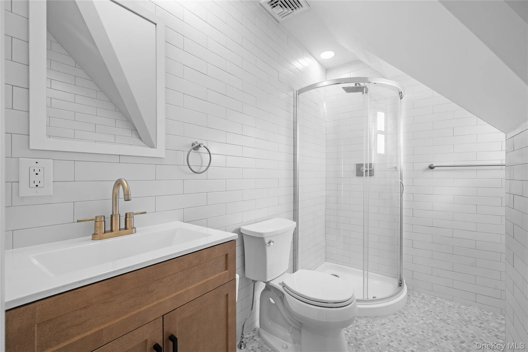 Bathroom featuring vanity, a shower stall, tile walls, and recessed lighting Bathroom featuring vanity, a shower stall, tile walls, and recessed lighting