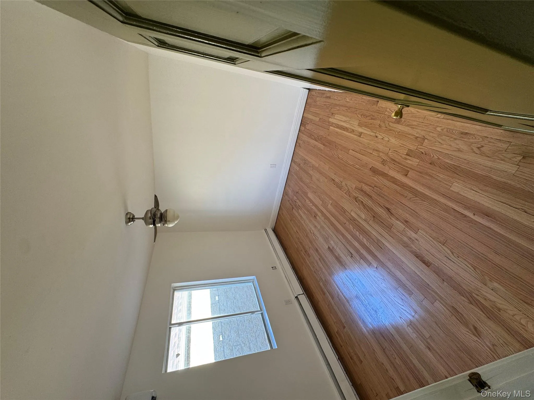 Spare room with baseboard heating, light wood-style flooring, and ceiling fan Spare room with baseboard heating, light wood-style flooring, and ceiling fan