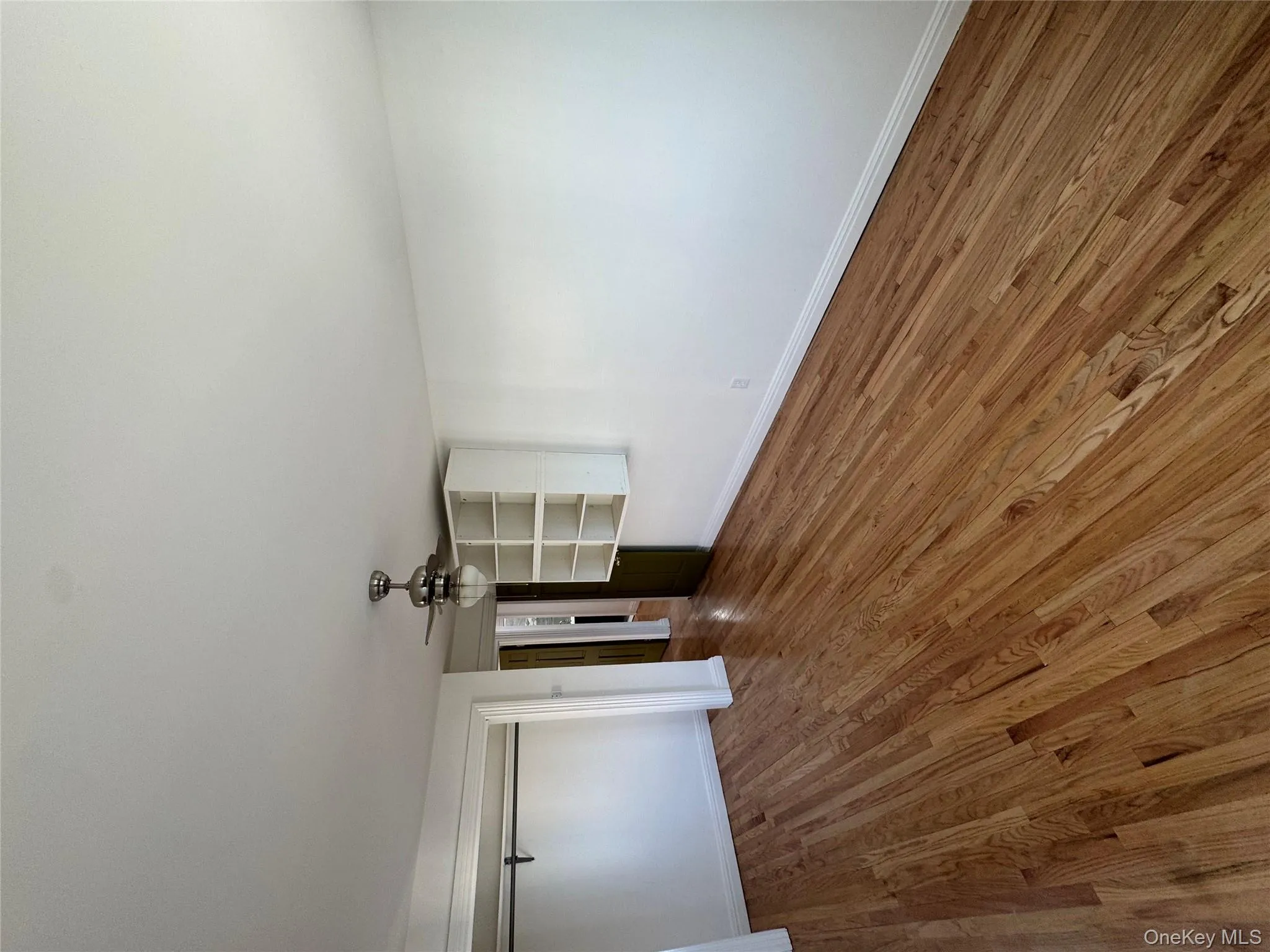 Unfurnished bedroom with ceiling fan, wood finished floors, and a closet Unfurnished bedroom with ceiling fan, wood finished floors, and a closet