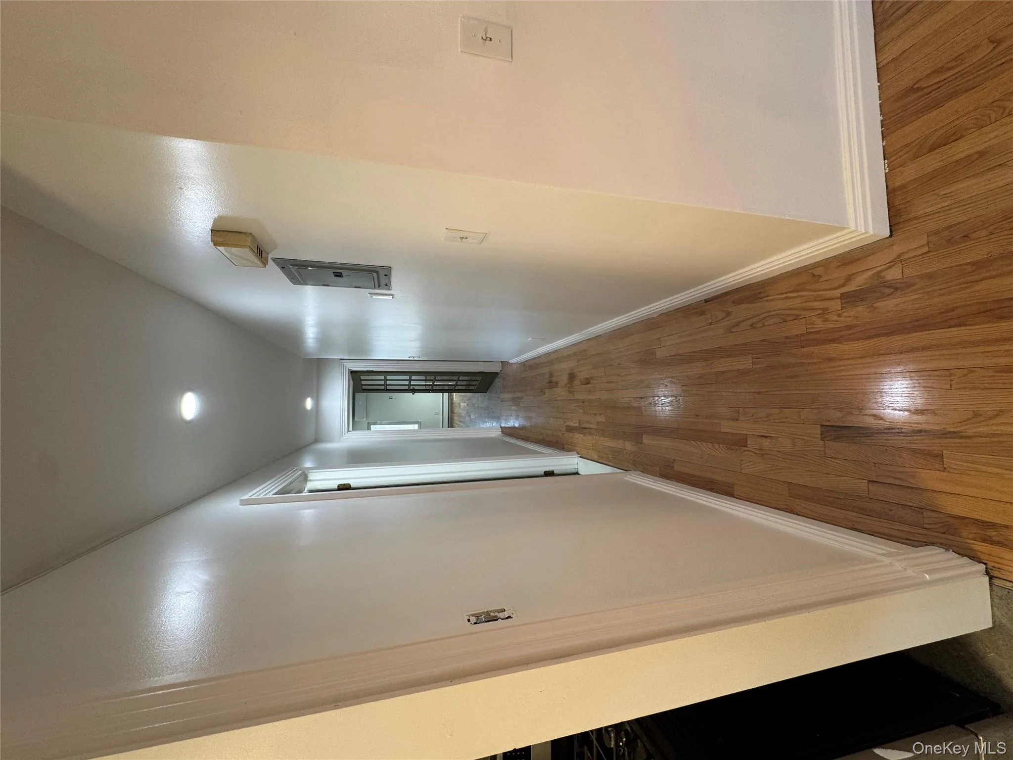 Hall with hardwood / wood-style flooring, recessed lighting, and electric panel Hall with hardwood / wood-style flooring, recessed lighting, and electric panel
