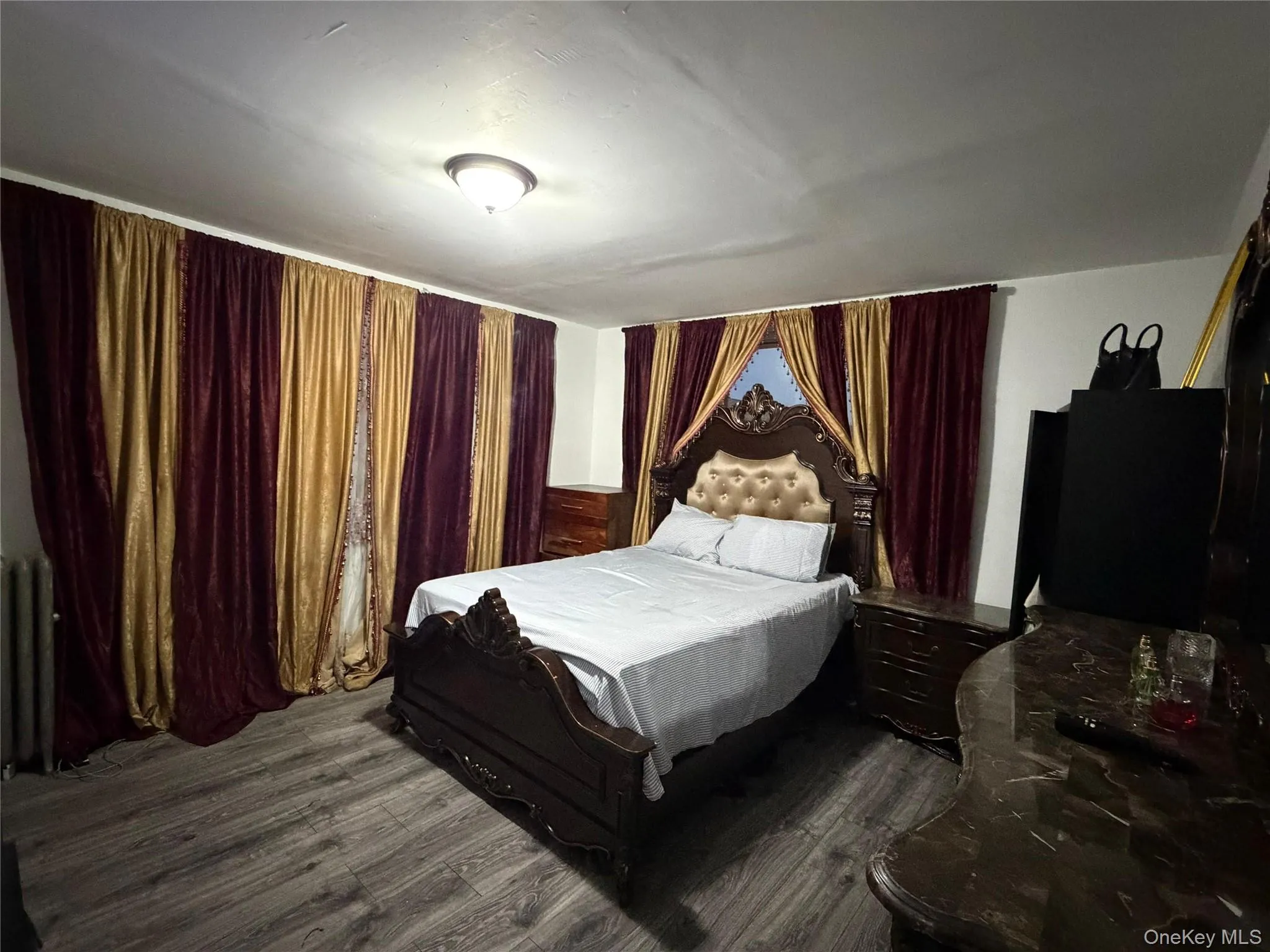 Bedroom featuring dark wood-style flooring Bedroom featuring dark wood-style flooring