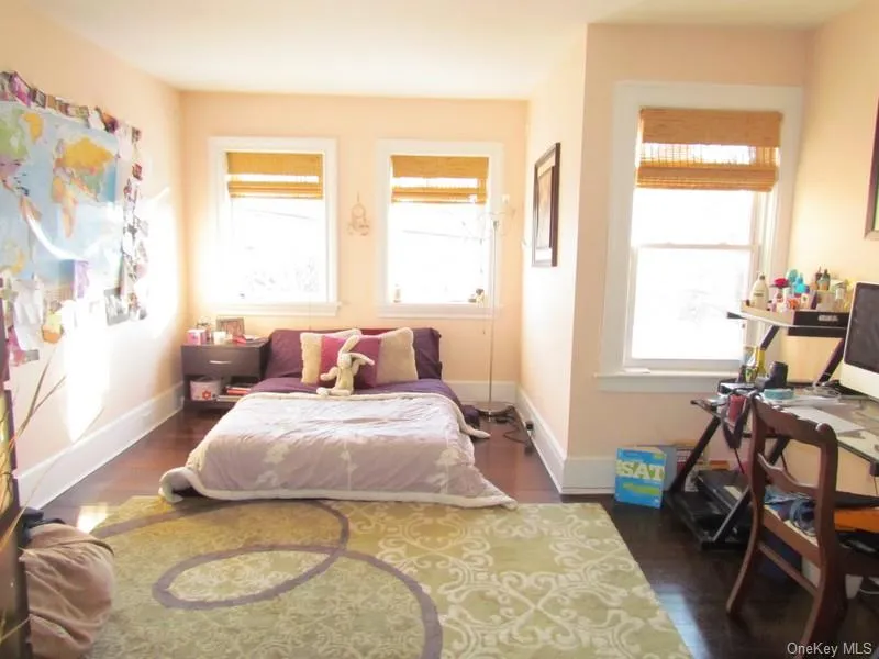 Bedroom with dark hardwood / wood-style floors Bedroom with dark hardwood / wood-style floors