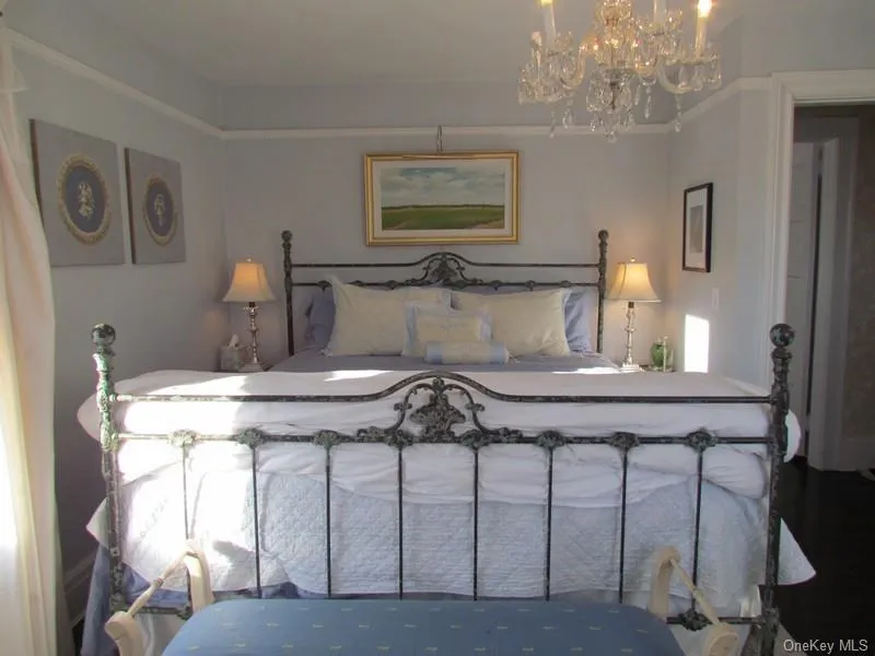 Bedroom featuring an inviting chandelier Bedroom featuring an inviting chandelier
