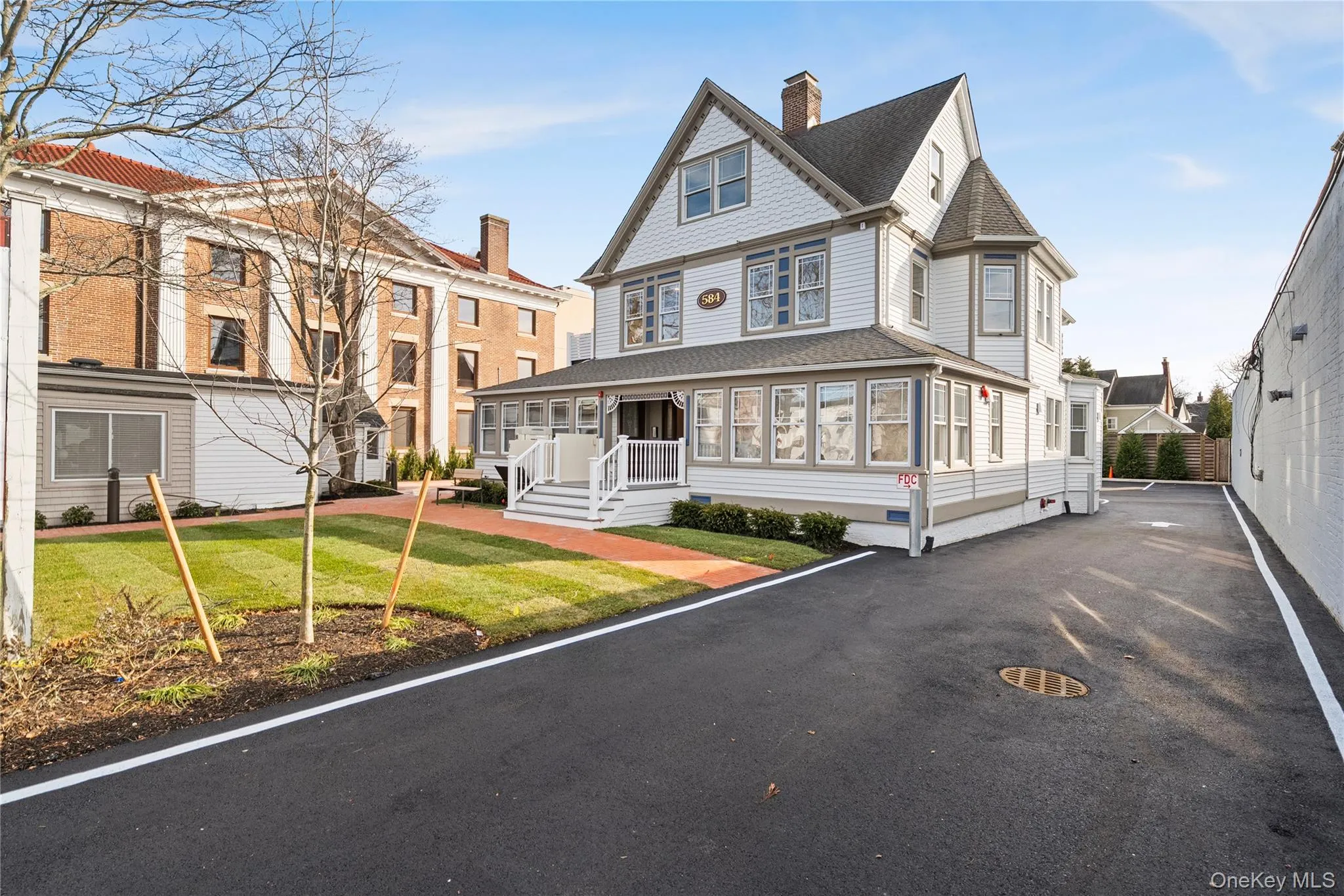 Victorian home with a sunroom, a shingled roof, a front lawn, a chimney, and crawl space Victorian home with a sunroom, a shingled roof, a front lawn, a chimney, and crawl space
