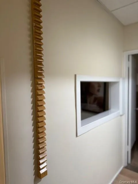 Detailed view of wood finished floors and a drop ceiling Detailed view of wood finished floors and a drop ceiling