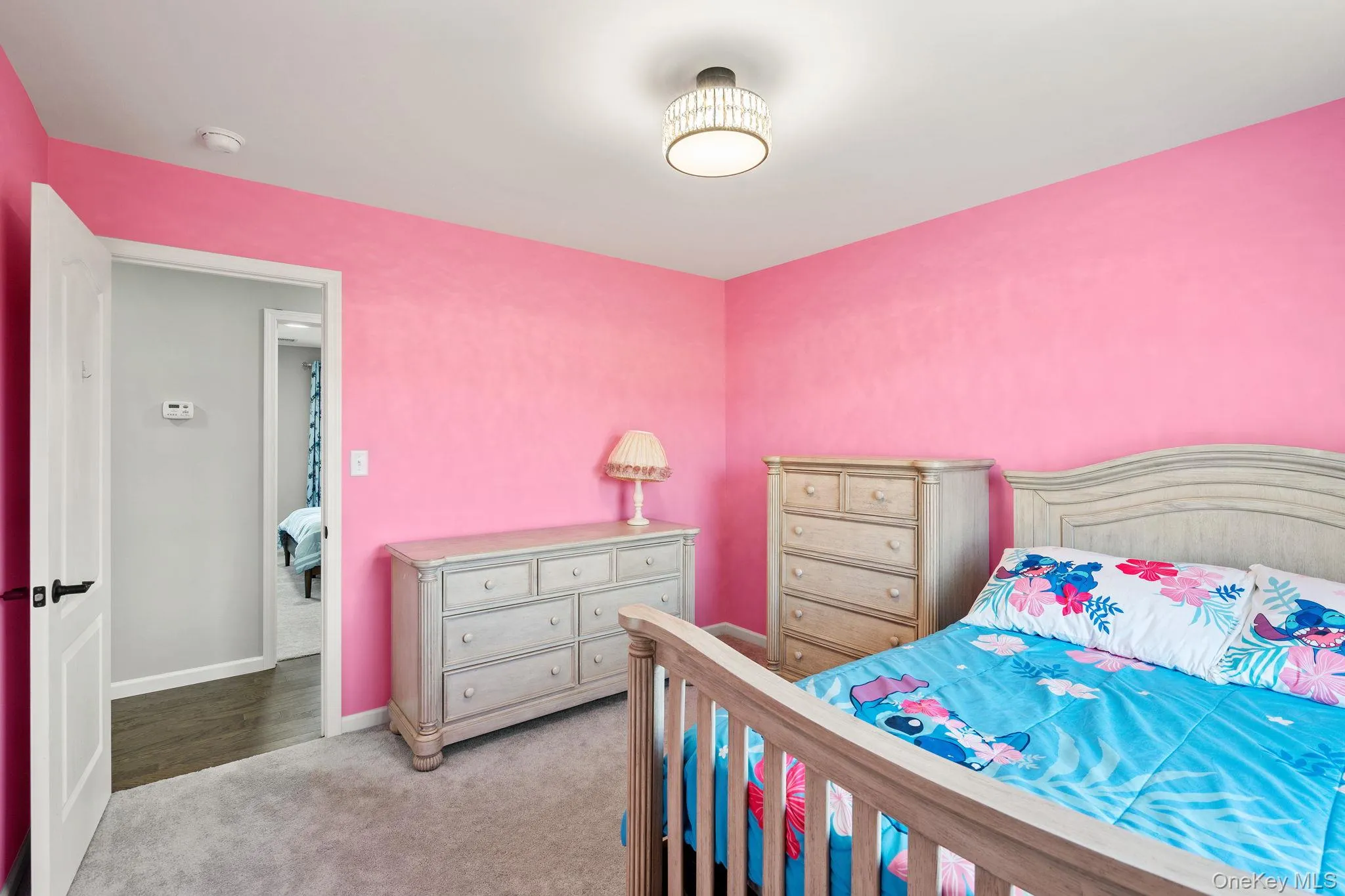 Bedroom with light carpet and baseboards Bedroom with light carpet and baseboards