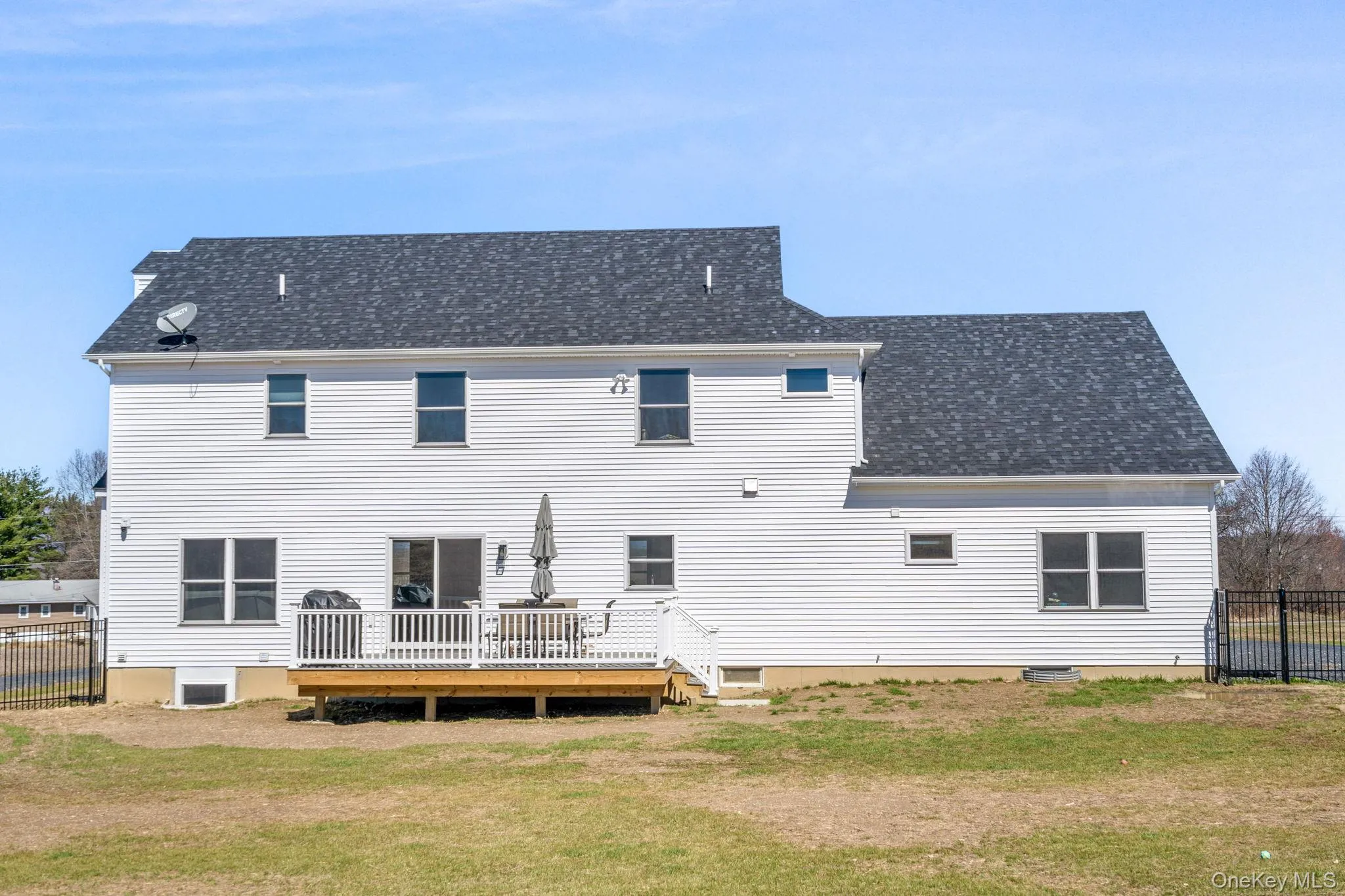 Back of property with a deck and roof with shingles Back of property with a deck and roof with shingles