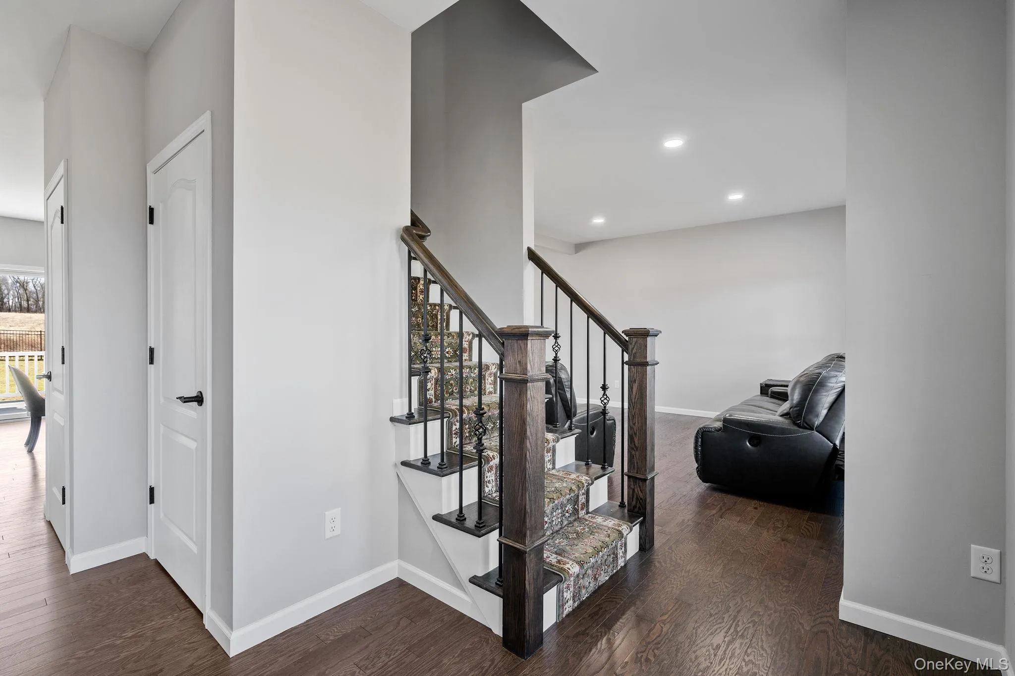 Stairway featuring hardwood / wood-style flooring and recessed lighting Stairway featuring hardwood / wood-style flooring and recessed lighting