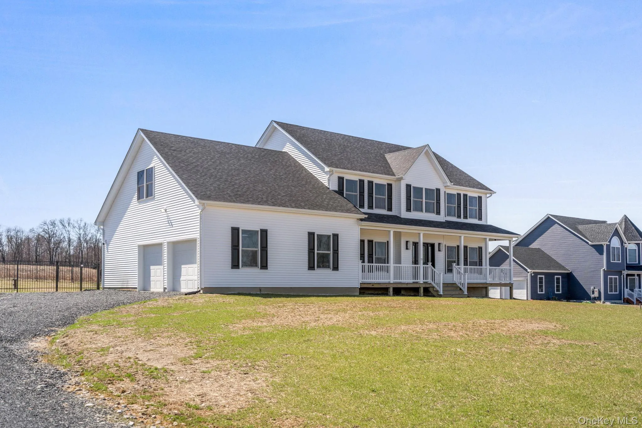 View of front of home with a porch, a front yard, driveway, roof with shingles, and an attached garage View of front of home with a porch, a front yard, driveway, roof with shingles, and an attached garage
