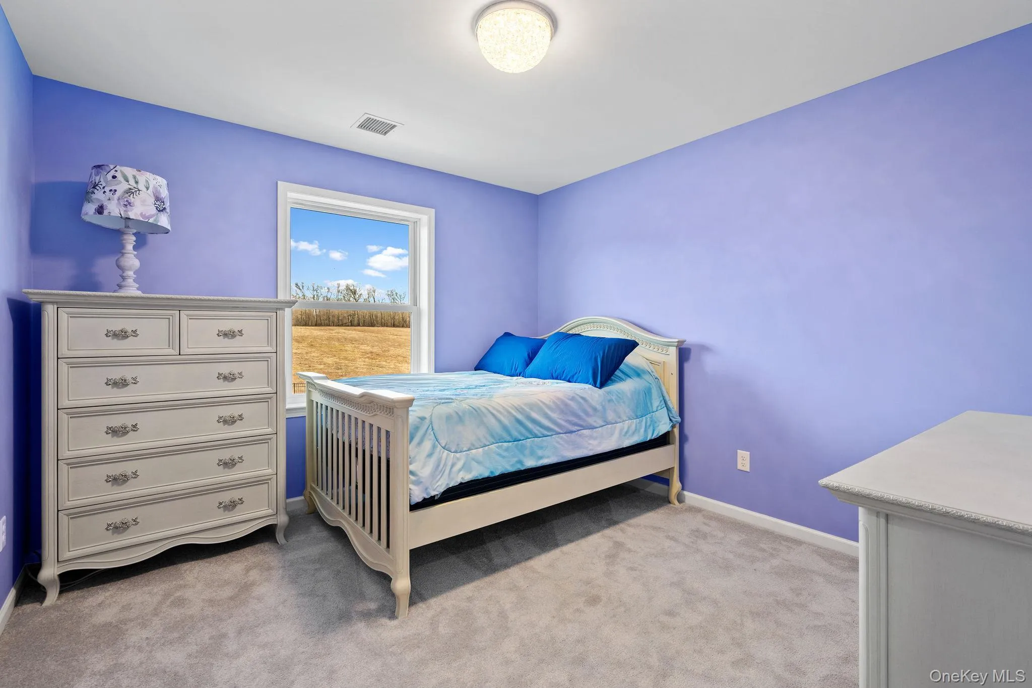 Bedroom with light carpet and baseboards Bedroom with light carpet and baseboards