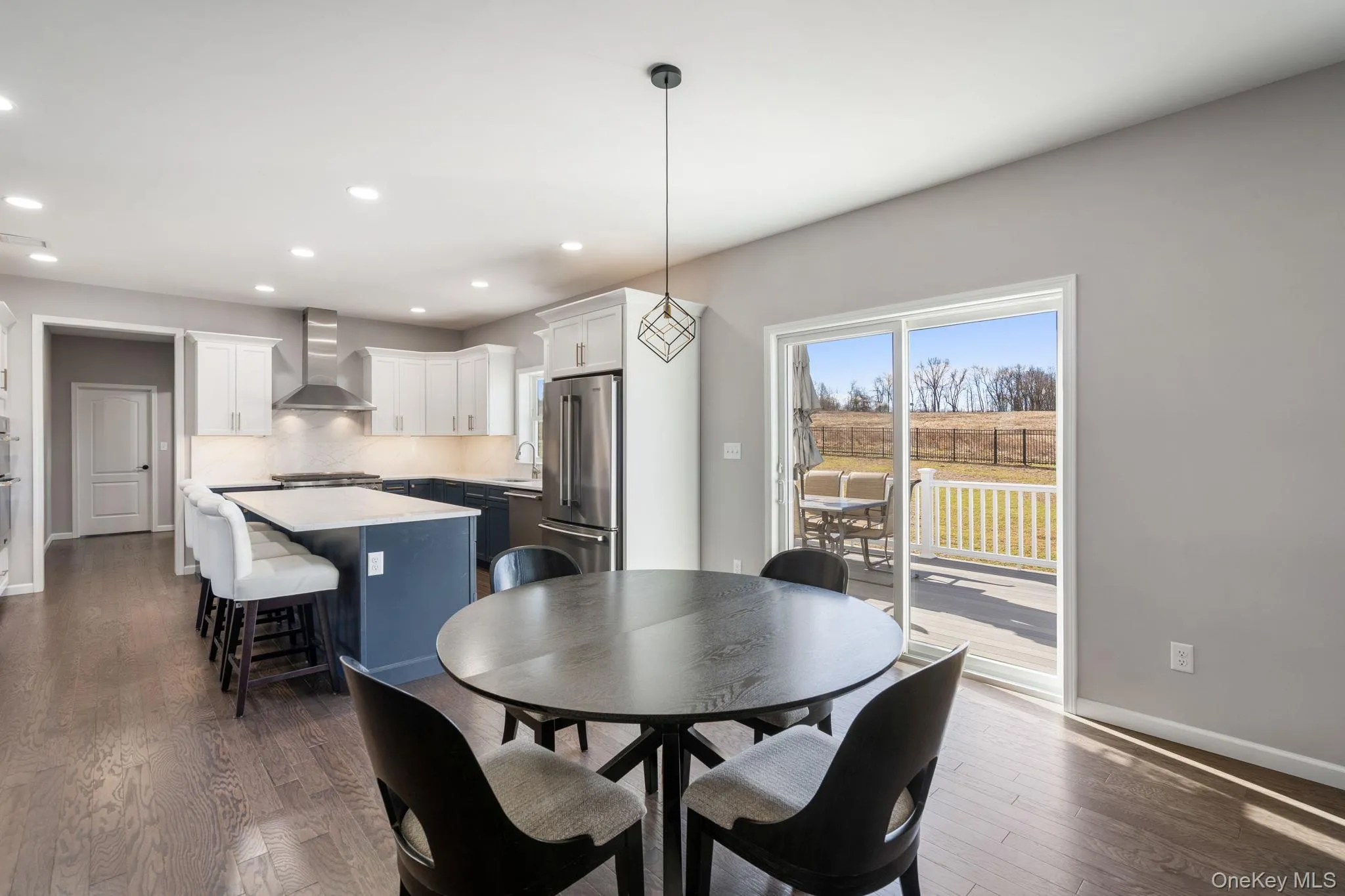 Dining area with recessed lighting and dark wood-style floors Dining area with recessed lighting and dark wood-style floors