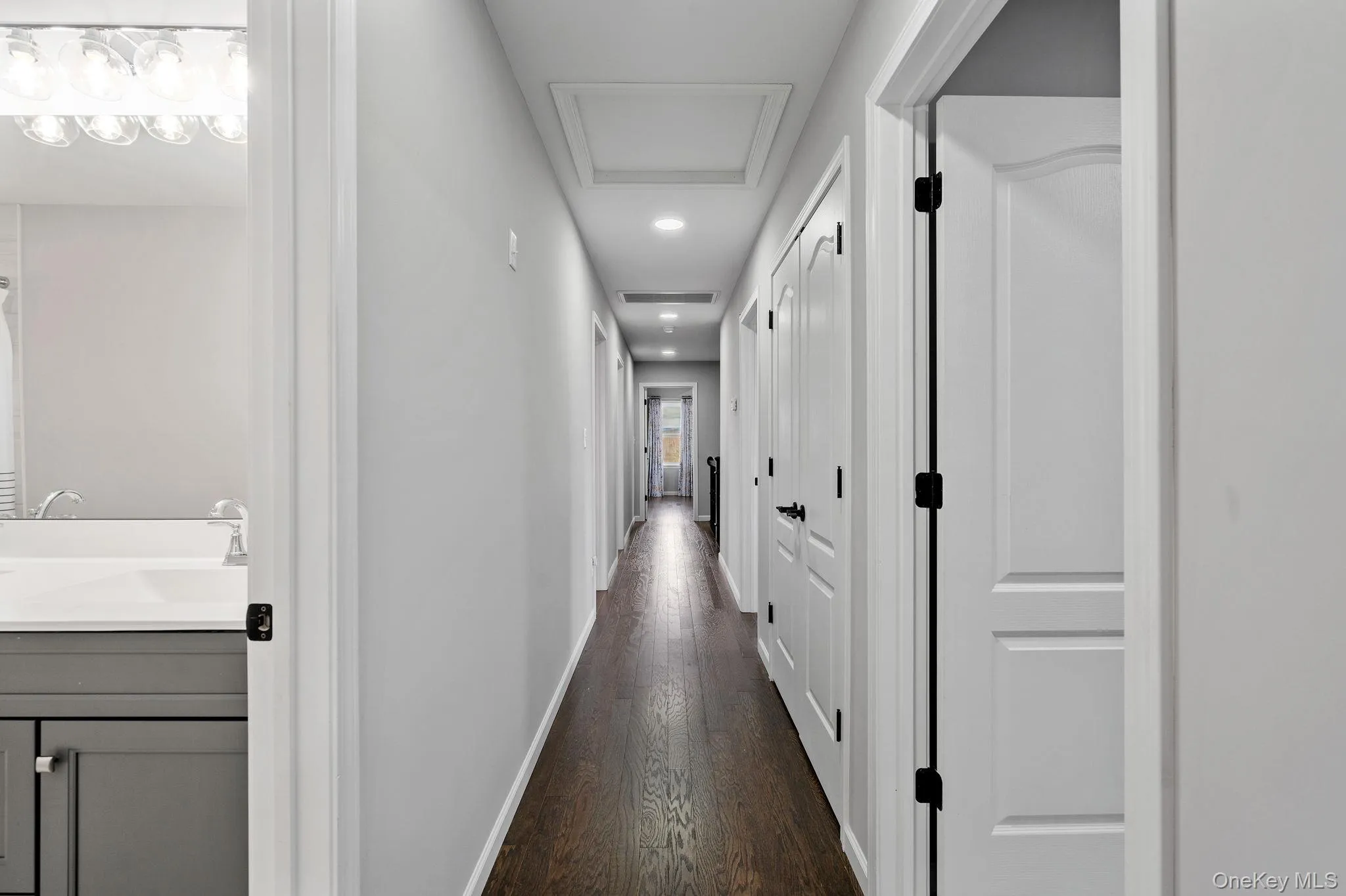 Hall featuring attic access, recessed lighting, and dark wood-type flooring Hall featuring attic access, recessed lighting, and dark wood-type flooring