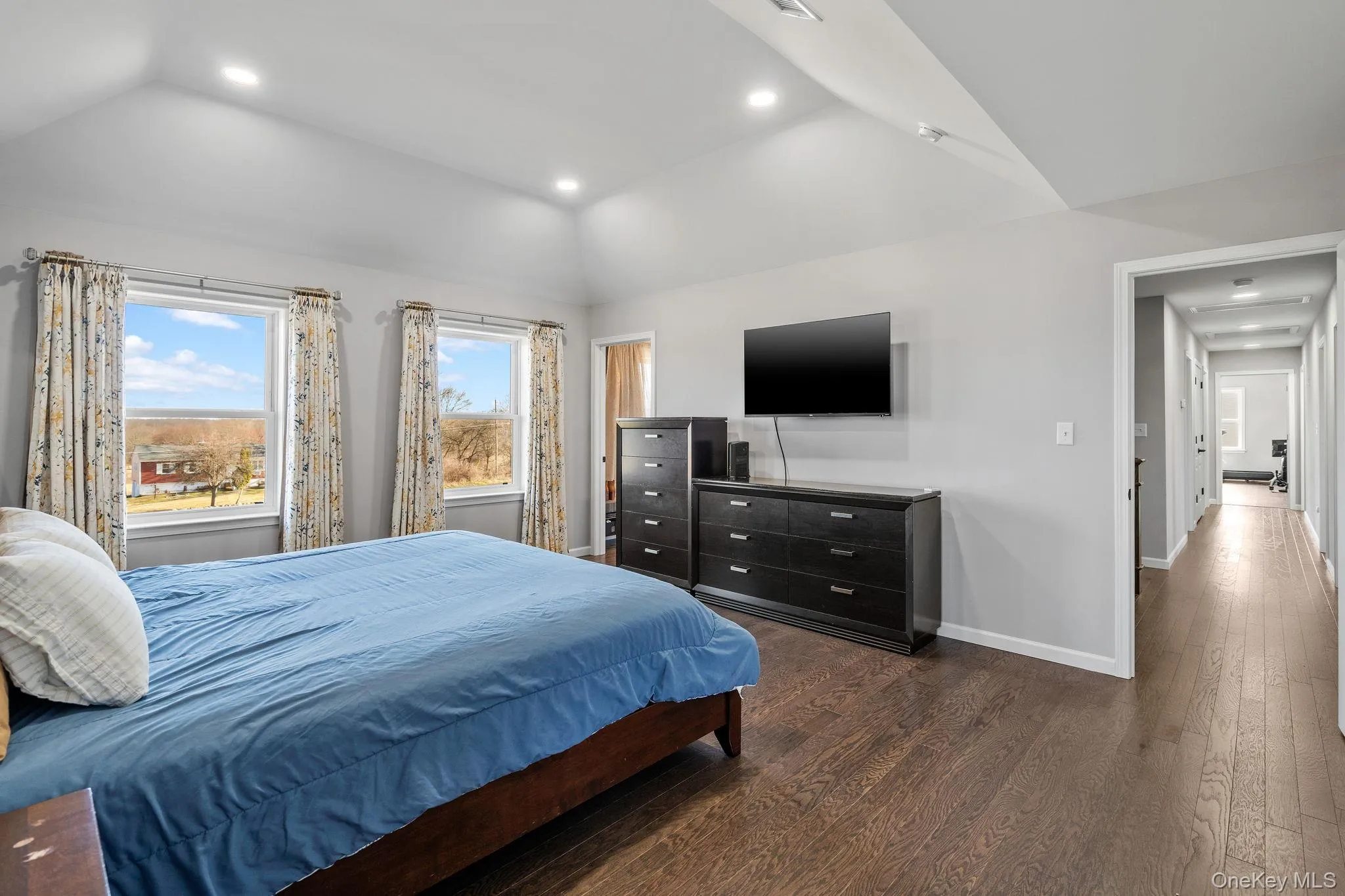 Bedroom with recessed lighting, dark wood-style floors, and lofted ceiling Bedroom with recessed lighting, dark wood-style floors, and lofted ceiling