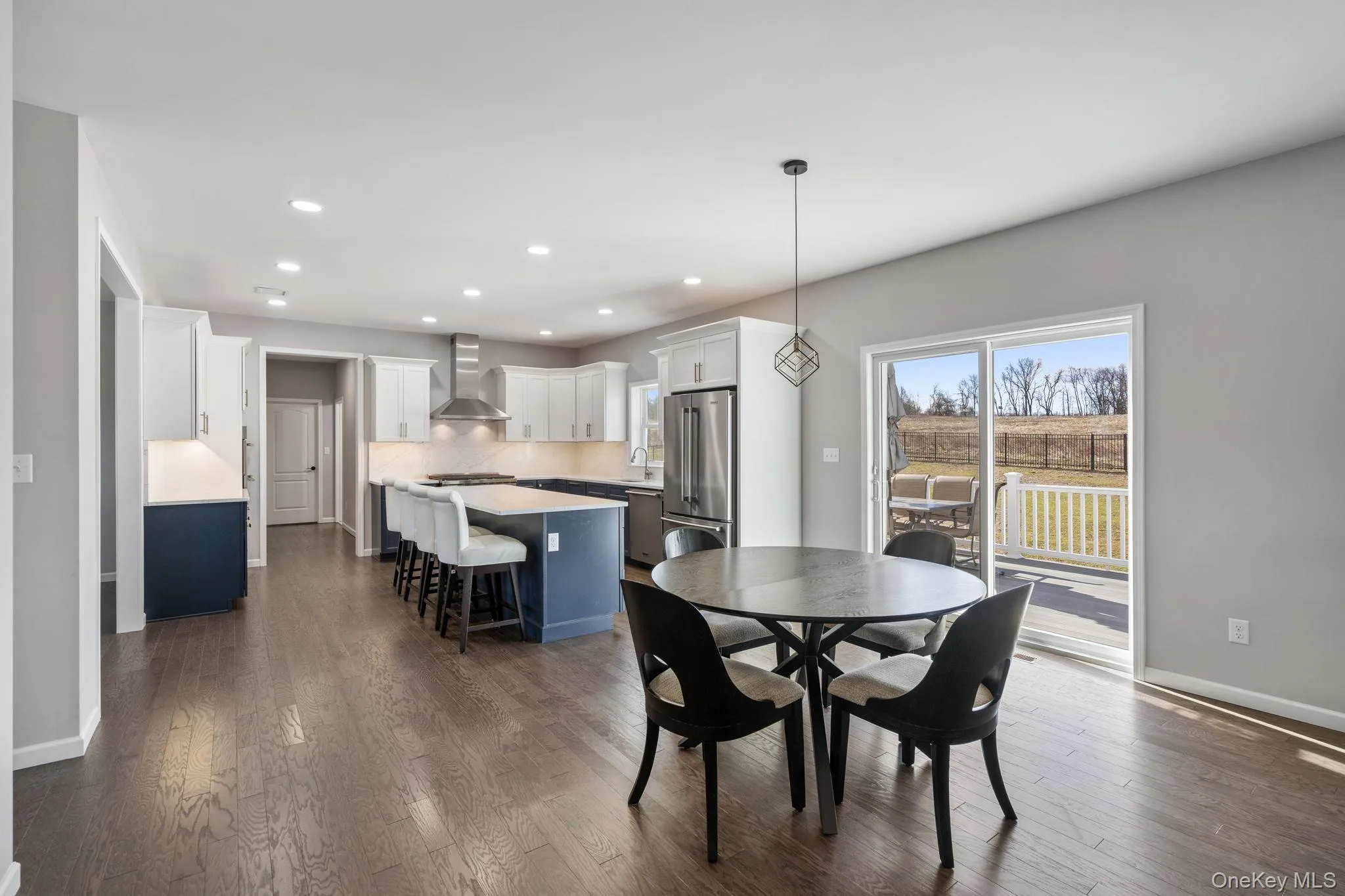 Dining space with recessed lighting and dark wood-style floors Dining space with recessed lighting and dark wood-style floors