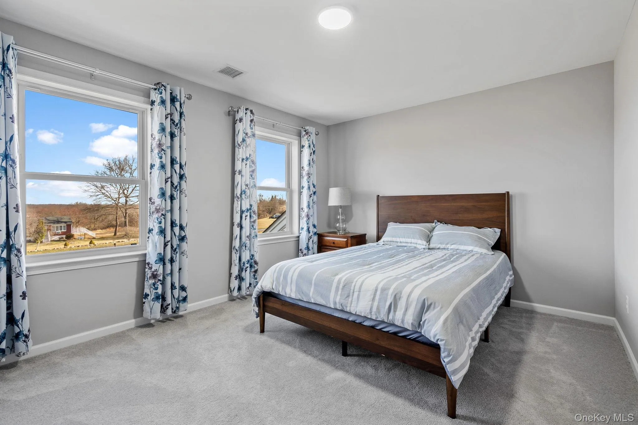 Bedroom featuring light carpet Bedroom featuring light carpet