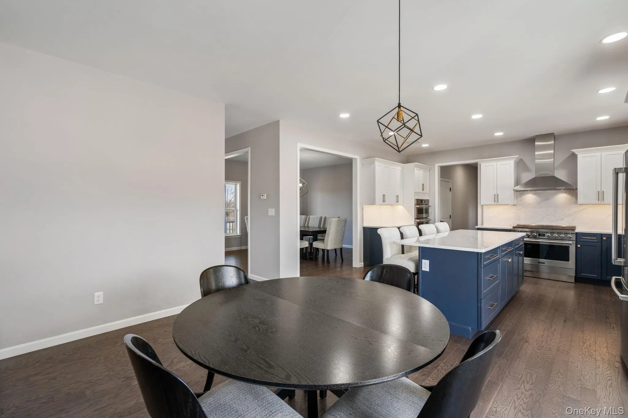 Dining room featuring recessed lighting and dark wood-style flooring Dining room featuring recessed lighting and dark wood-style flooring