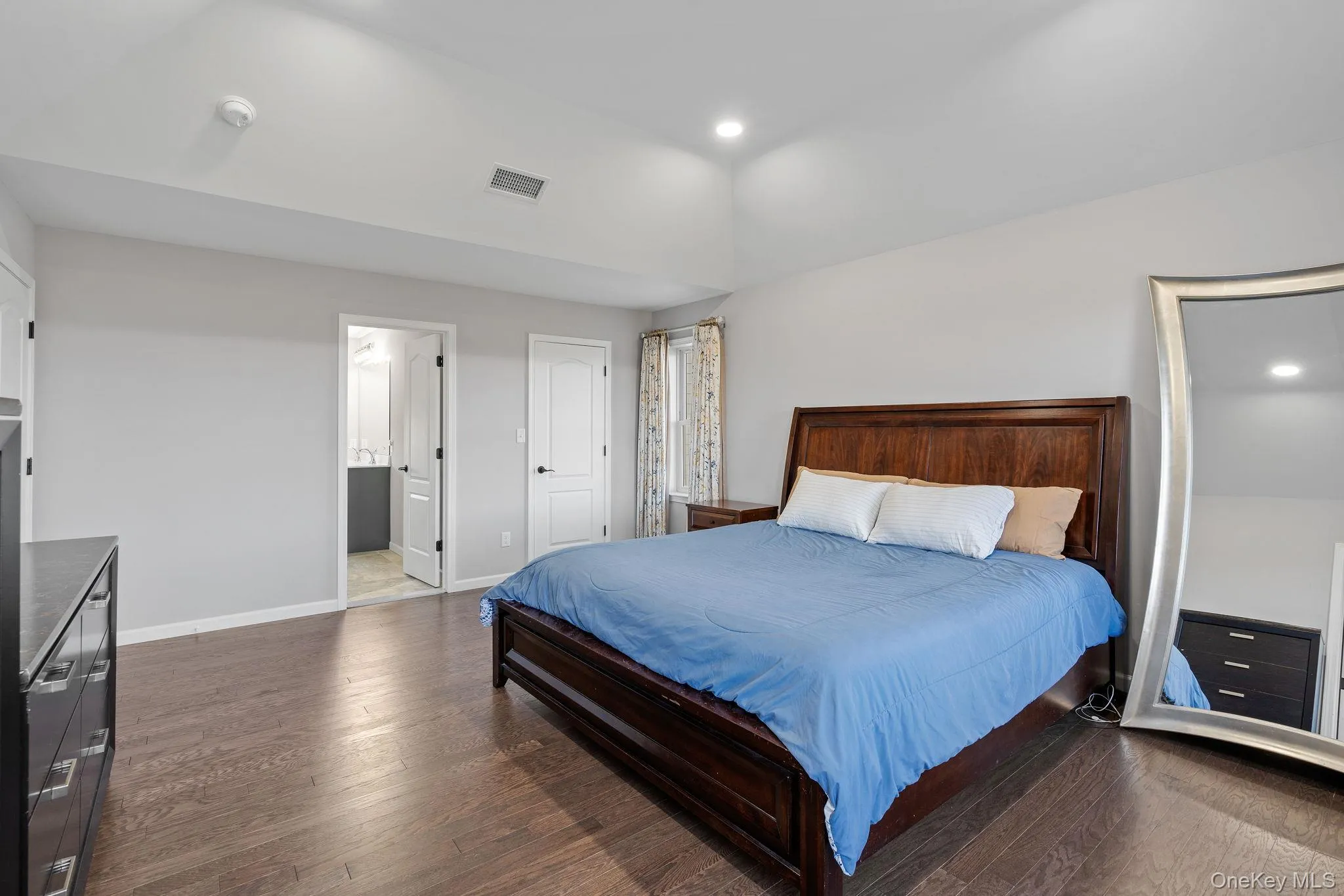 Bedroom with dark wood-type flooring and recessed lighting Bedroom with dark wood-type flooring and recessed lighting