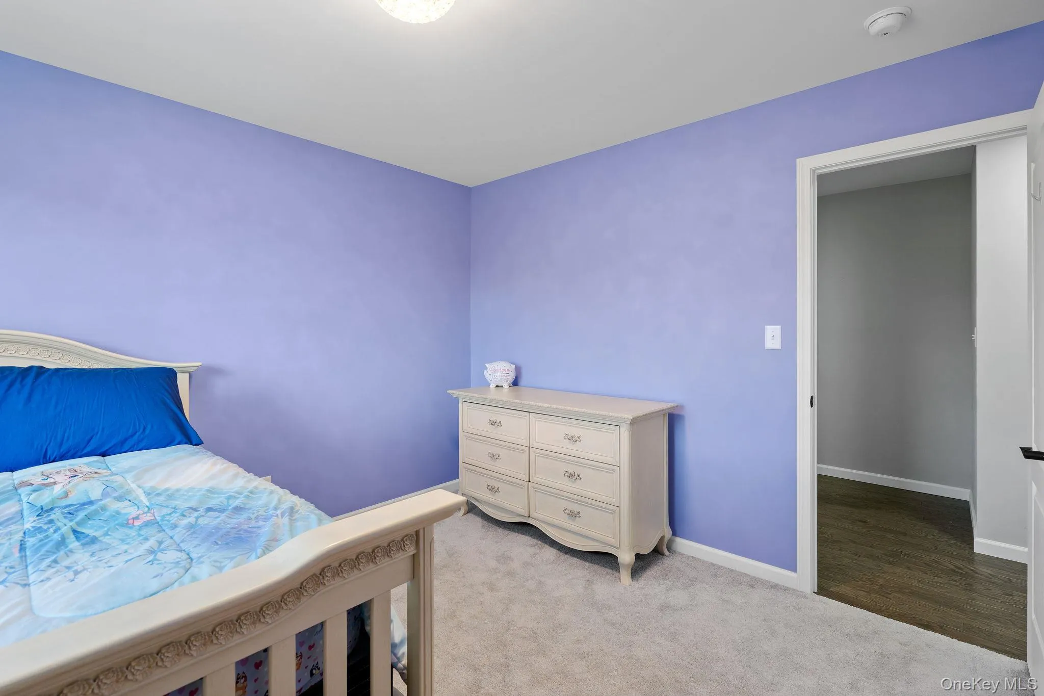 Bedroom featuring light colored carpet and baseboards Bedroom featuring light colored carpet and baseboards