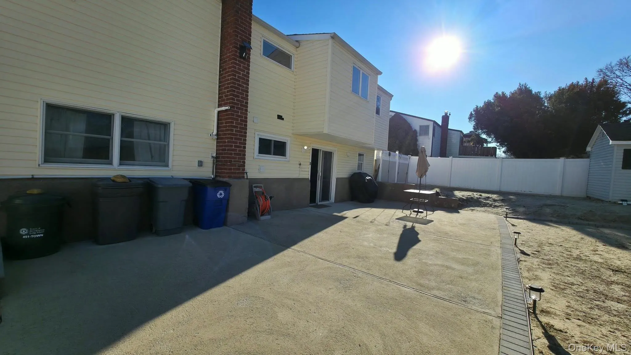 Rear view of house with a patio area Rear view of house with a patio area