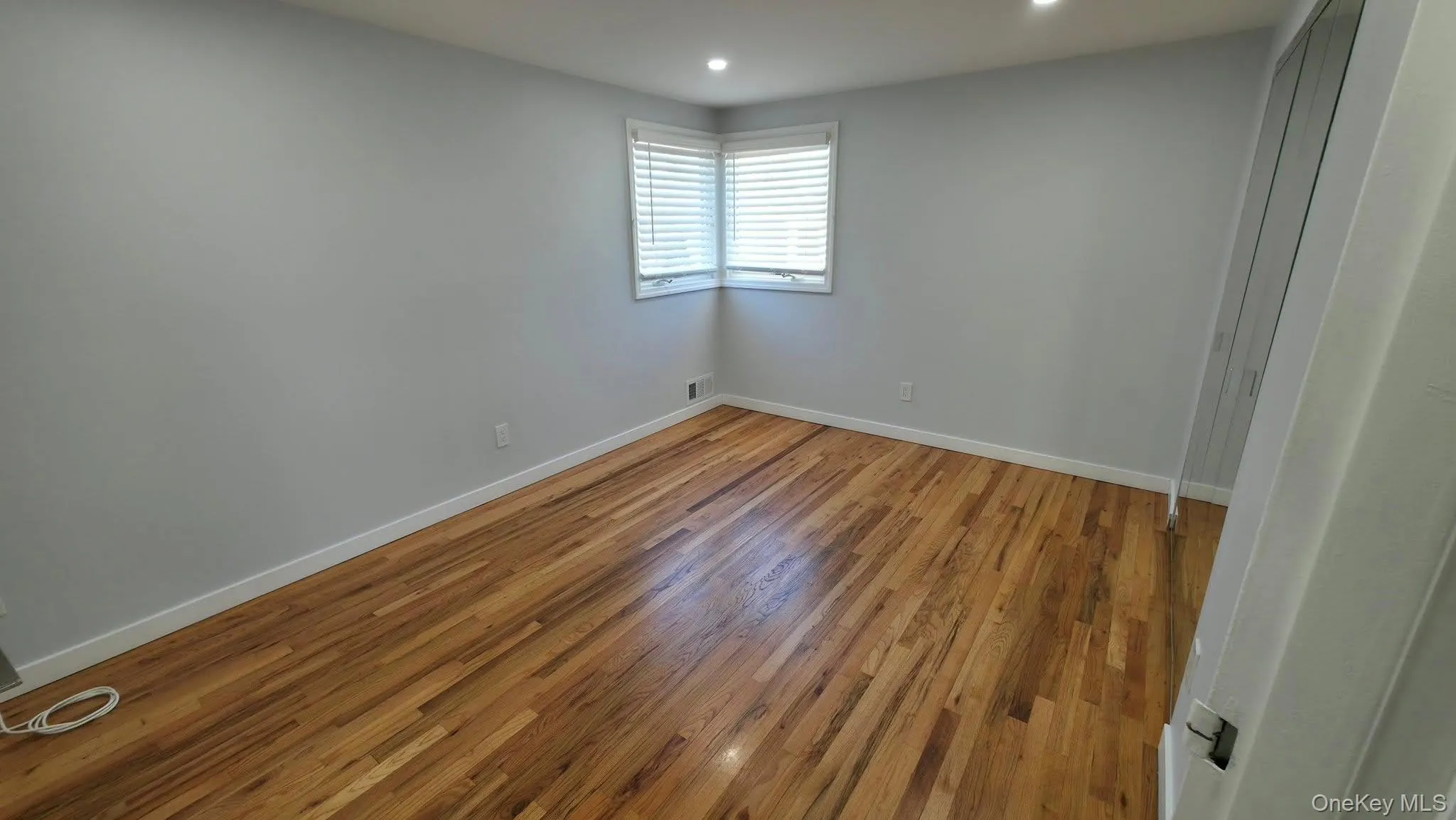 Unfurnished room with light wood-type flooring and recessed lighting Unfurnished room with light wood-type flooring and recessed lighting